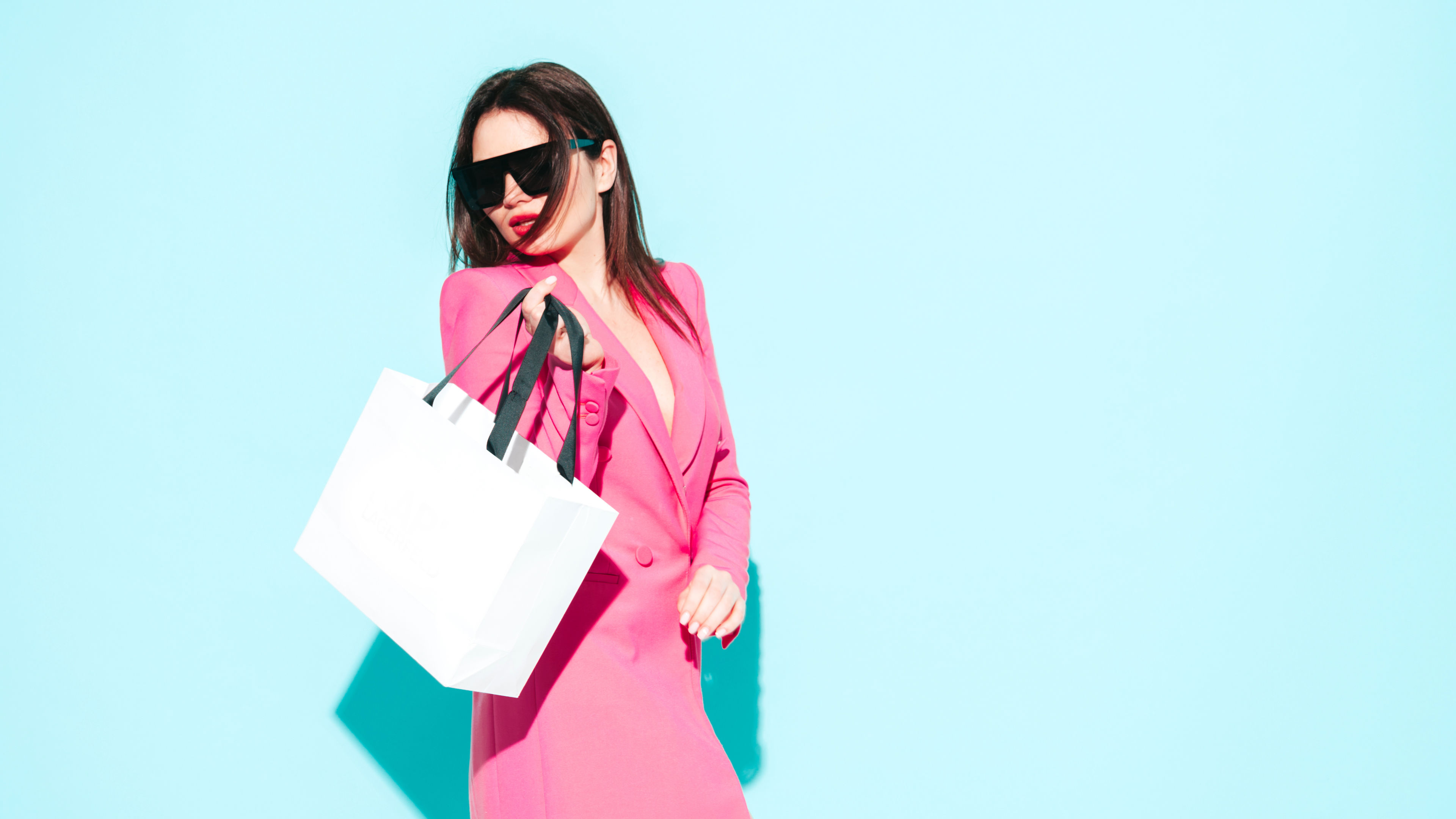 High fashion portrait of young beautiful brunette woman wearing nice pink summer suit