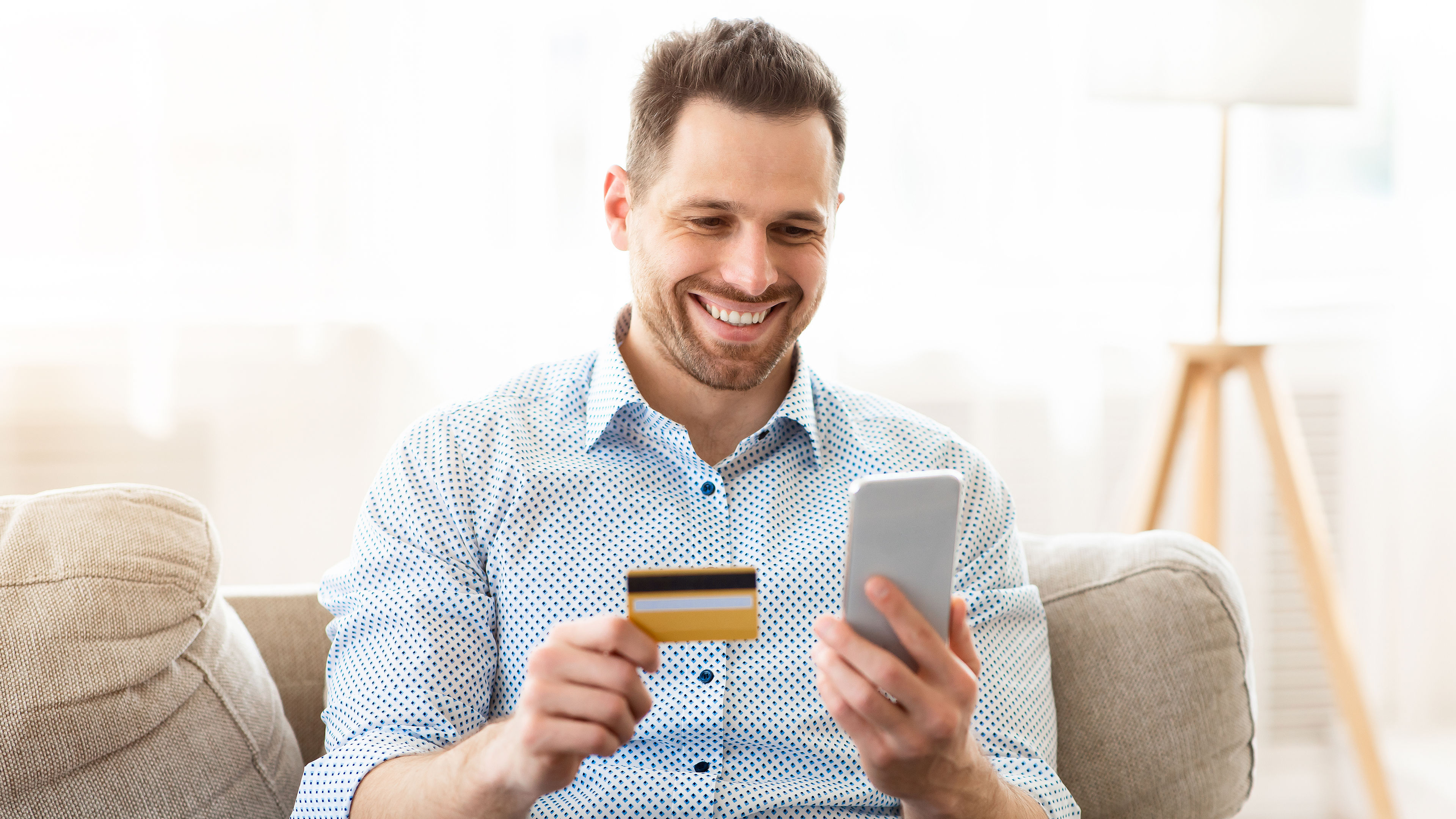 A happy man with a card in hand  