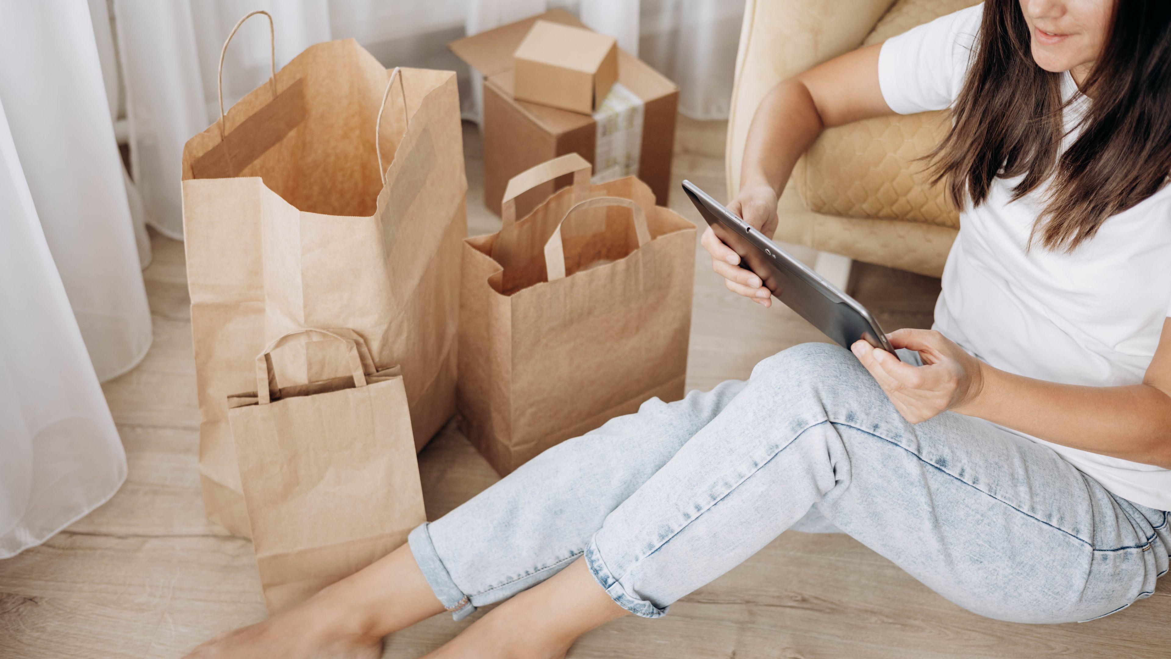 Woman using tablet for online shopping at home 