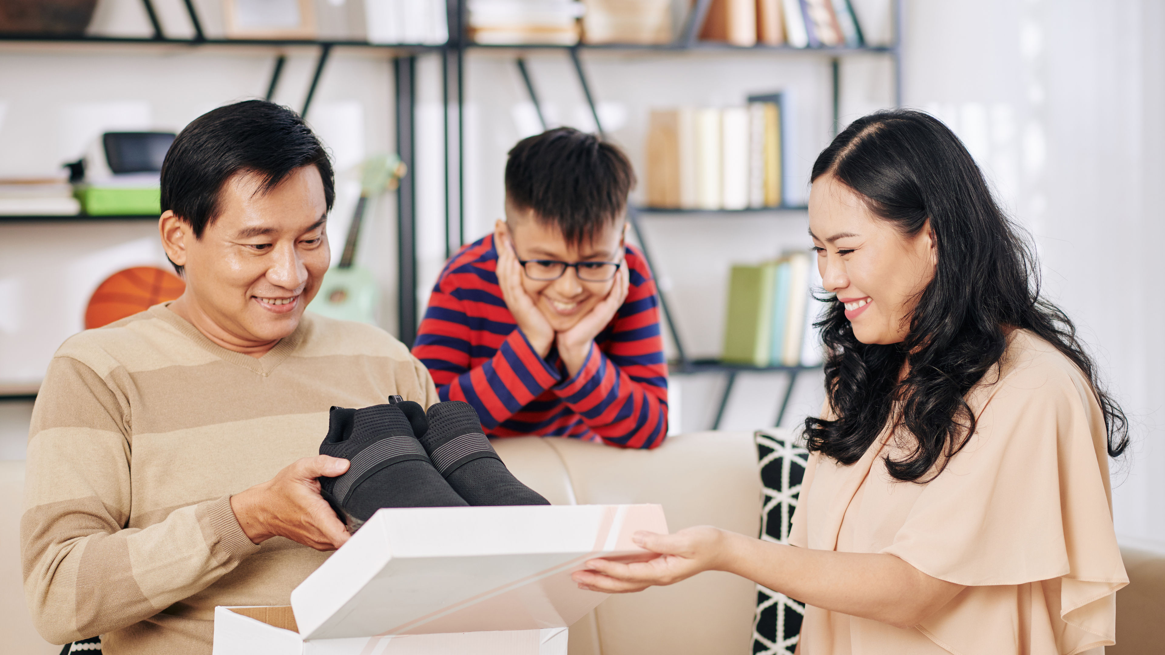 A man opening shoe with family 