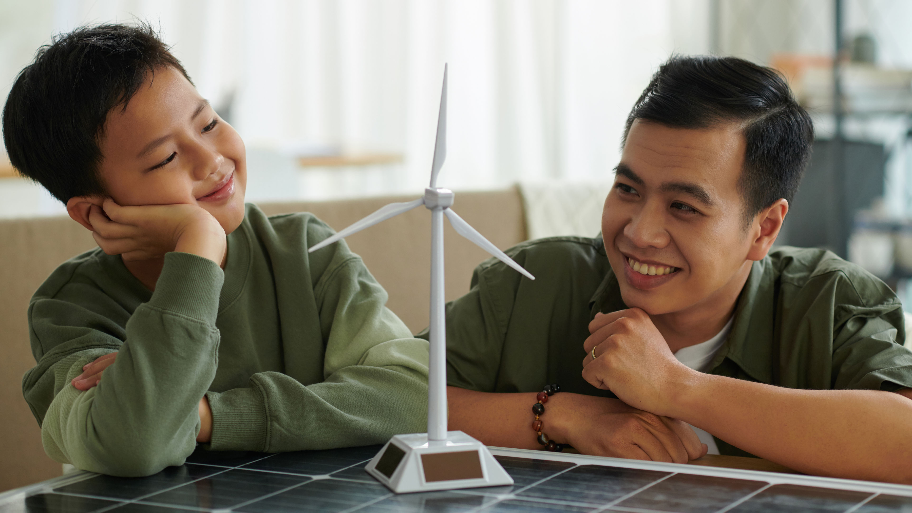 Father and son looking at wind turbine 