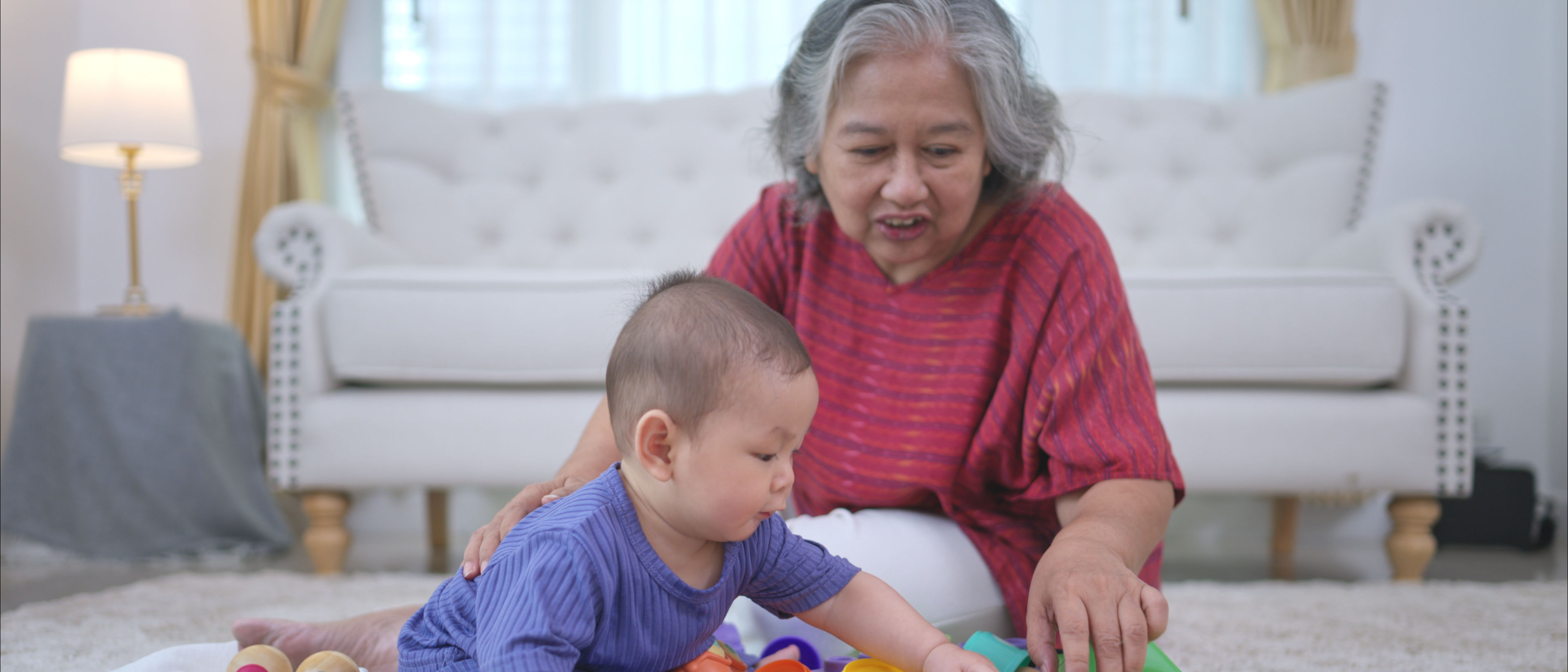 Grandmother and their little grandchild play happily