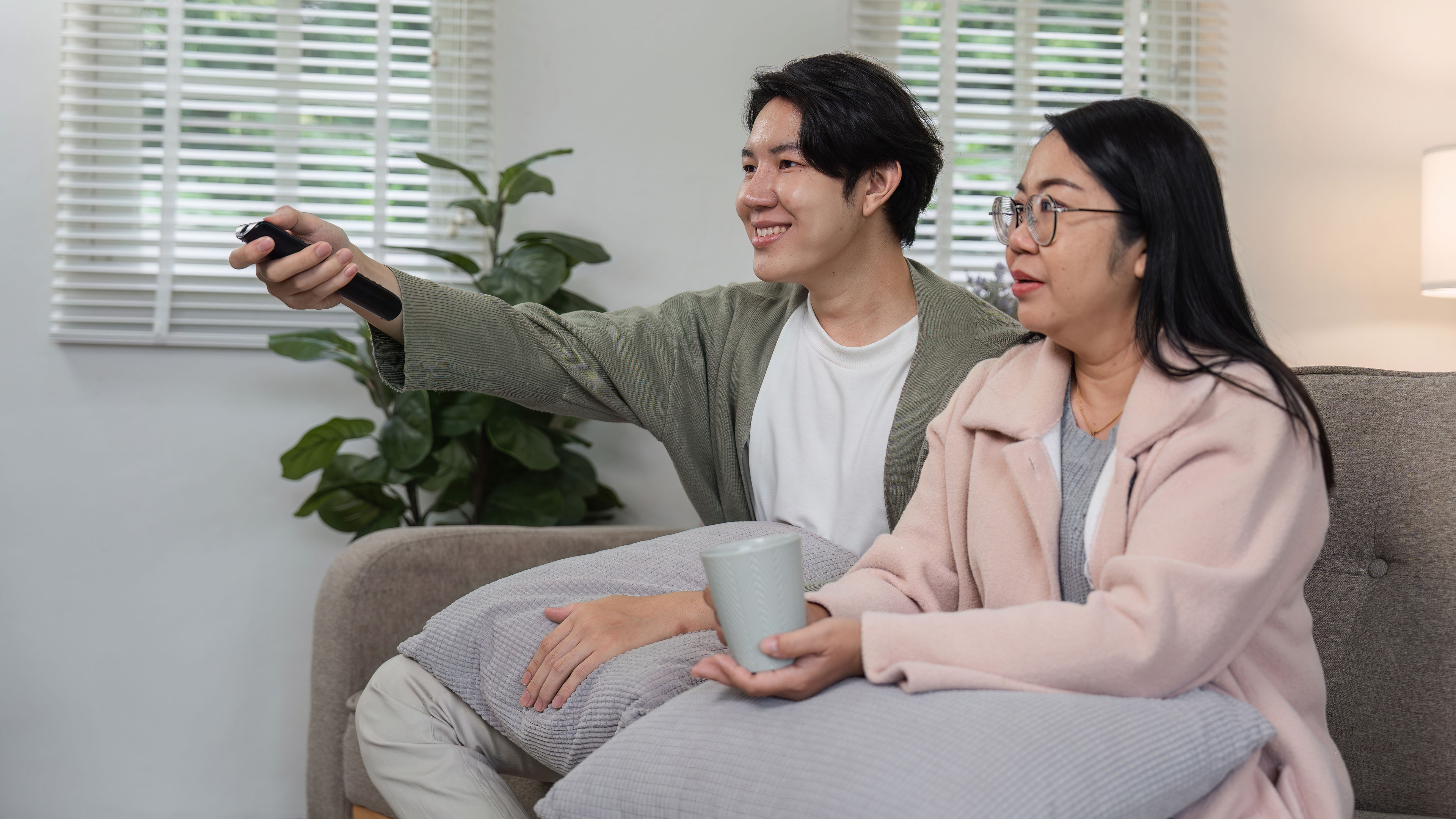 Mother and Son Relaxing Together and Watching TV and Enjoying Quality Time on 