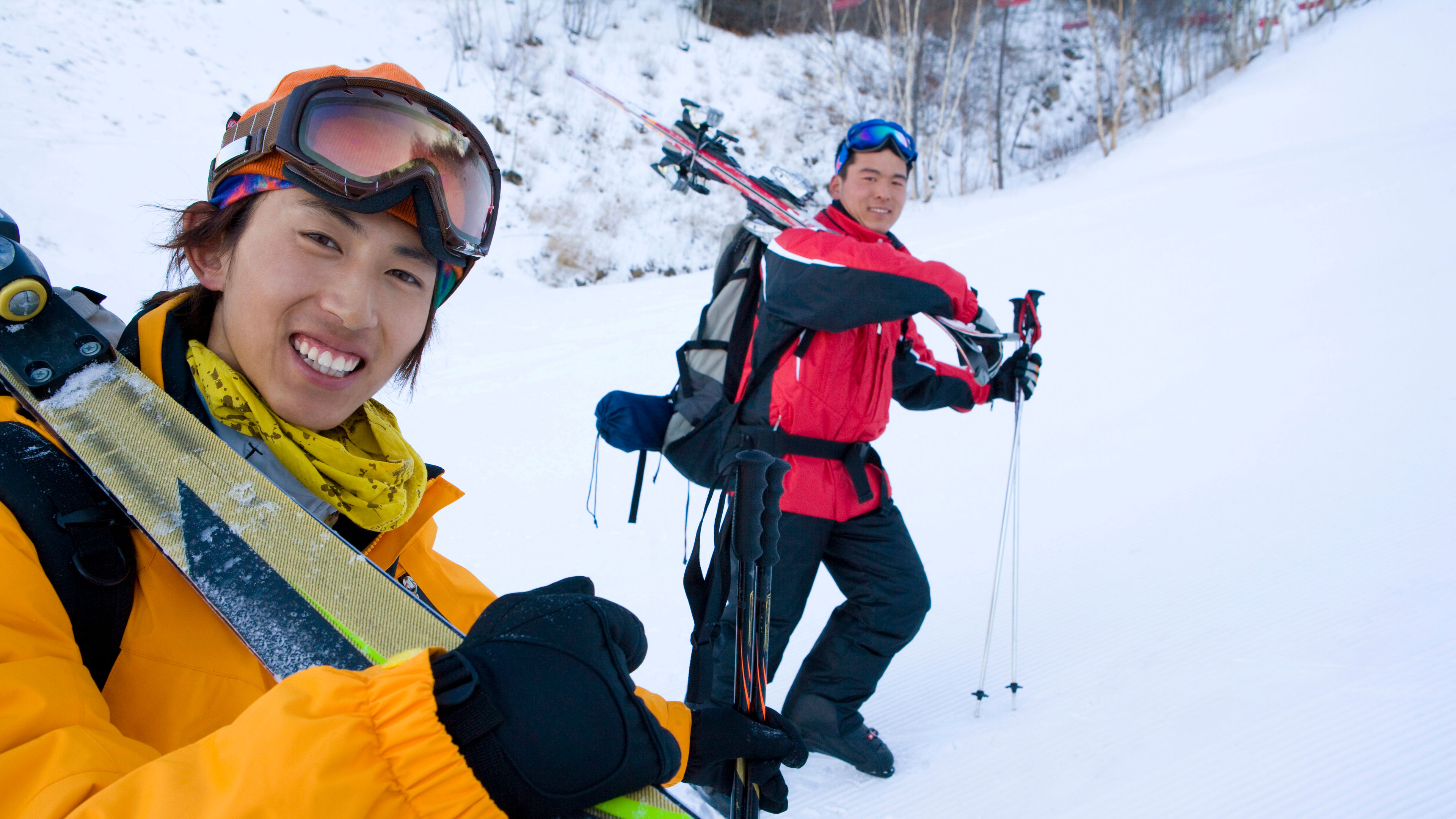 Two young men smiling and hiking 