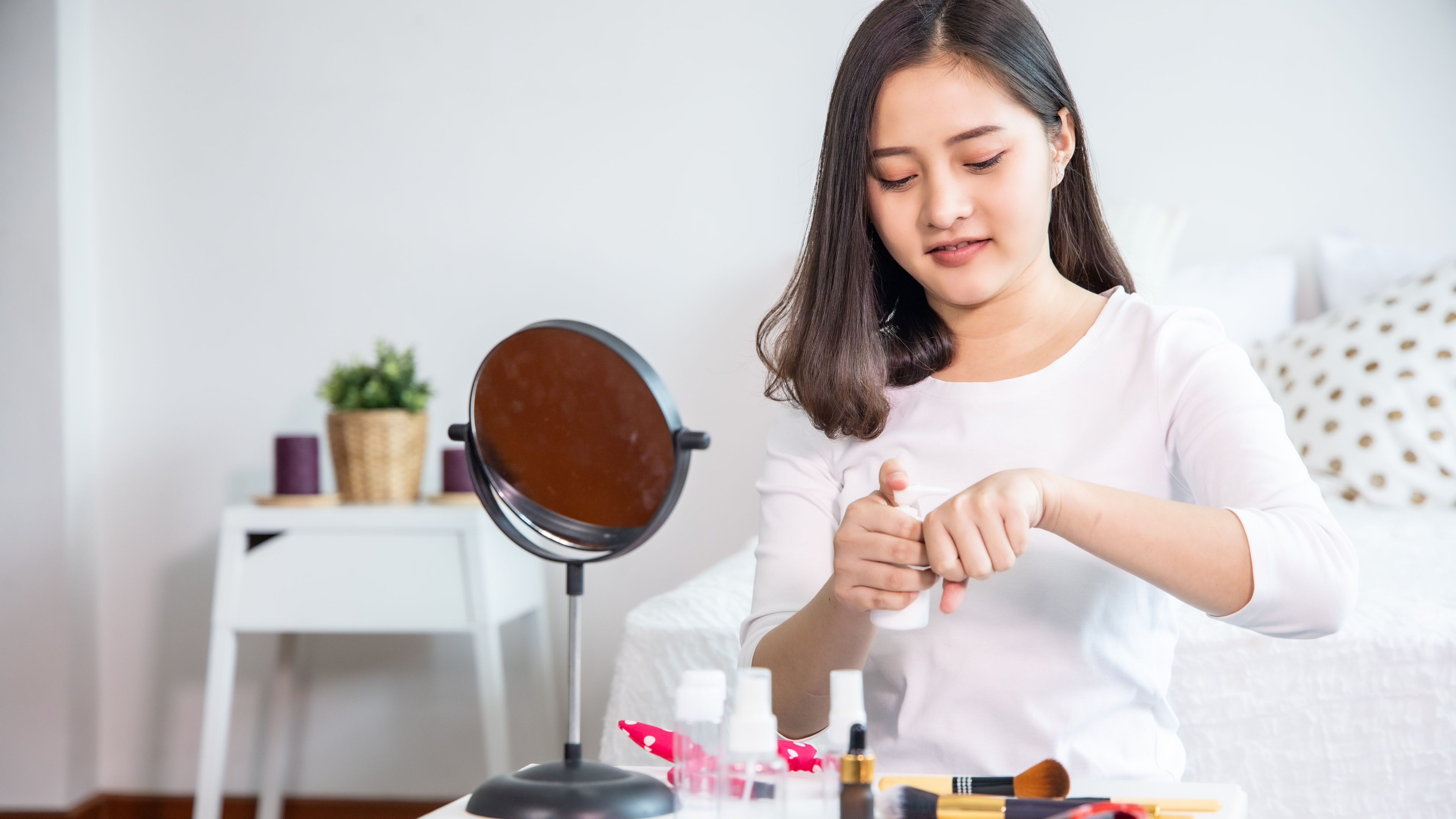 Woman testing cream on her wrist 