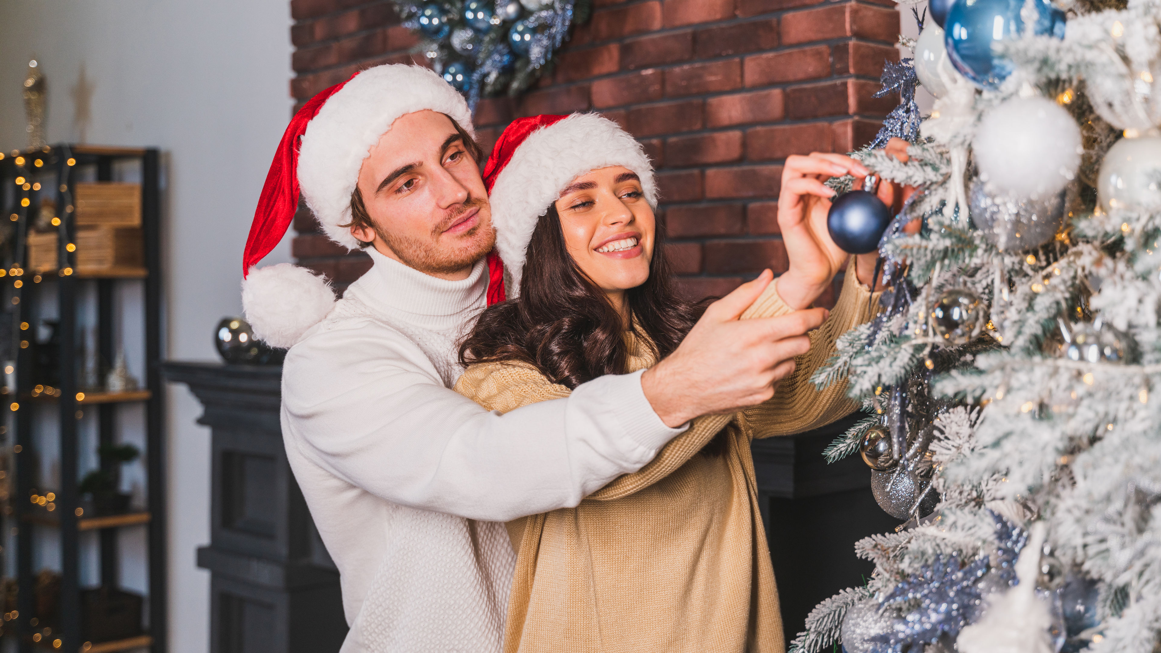 Happy couple celebrating Christmas at home. 
