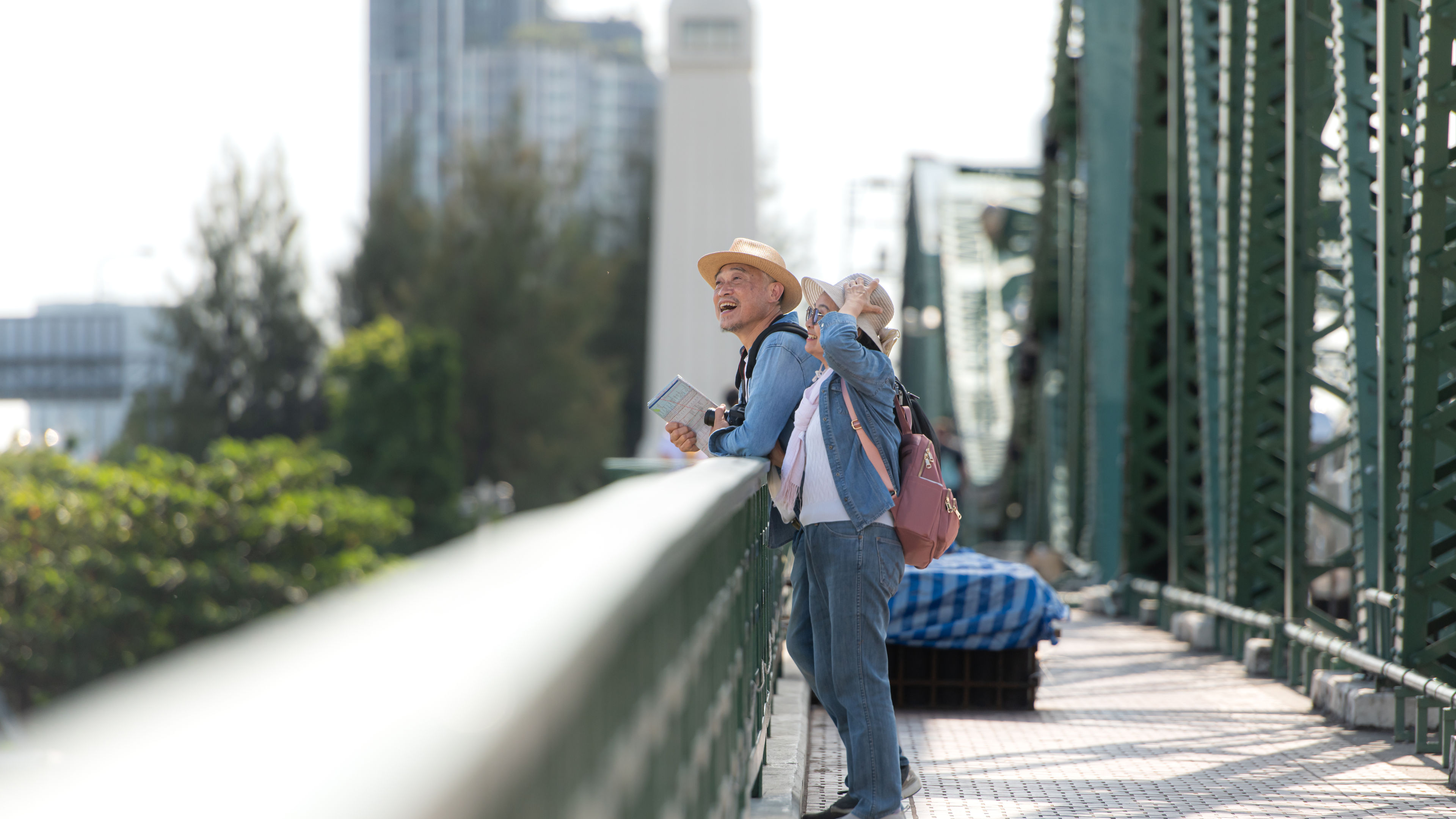 Elderly couples travel on the old iron bridge  