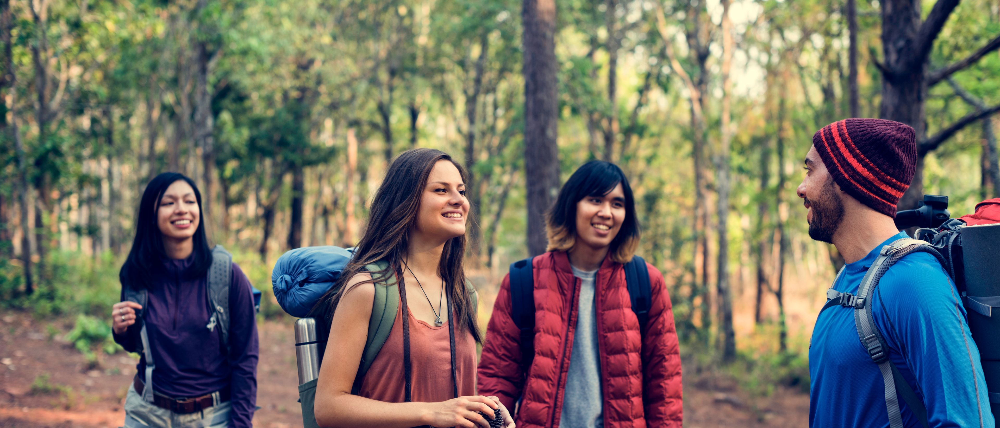 
Friends exploring nature outdoors, enjoying the beauty of the natural environment together.
