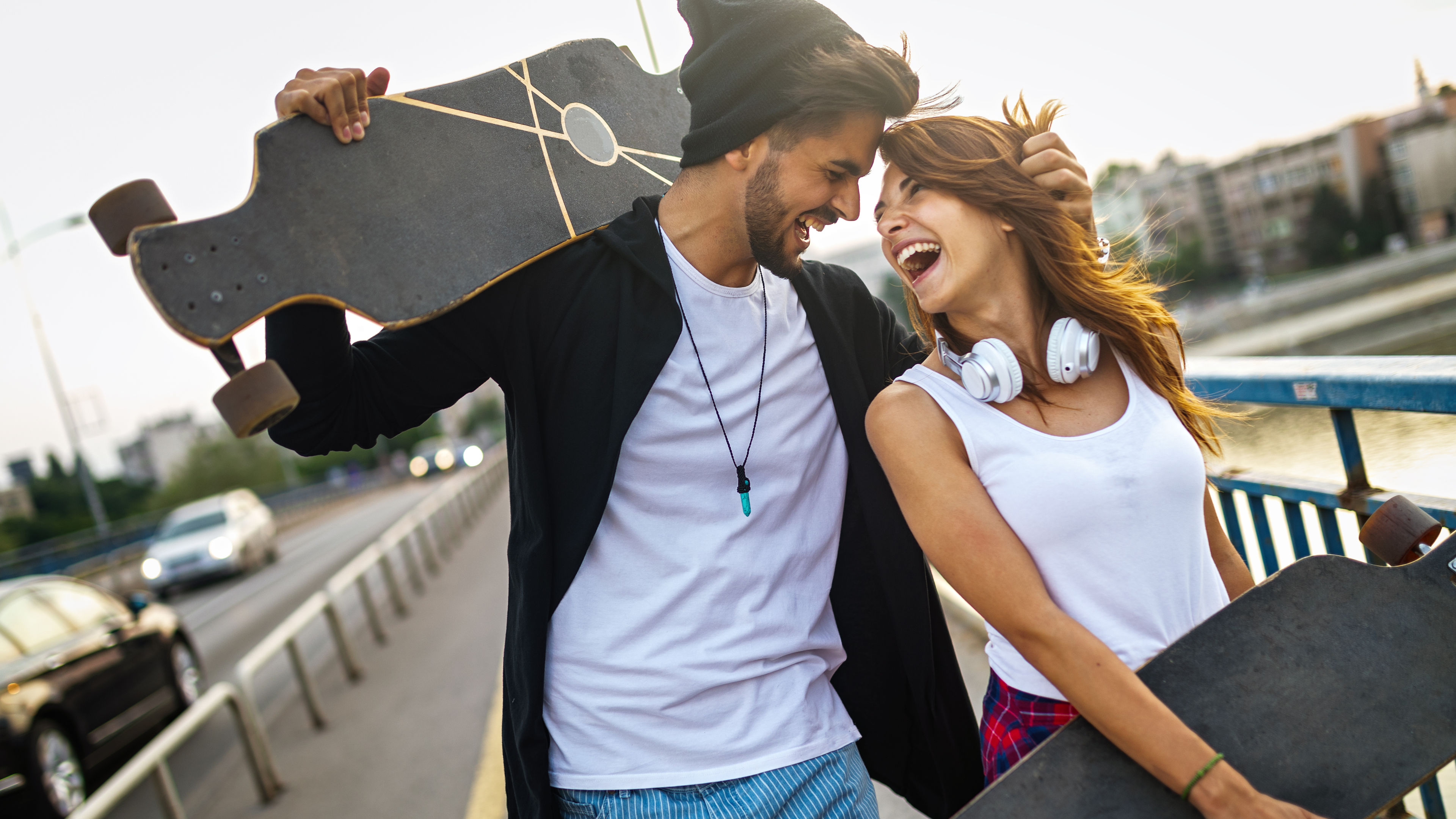 Portrait of young happy people with skateboards having fun together outdoors