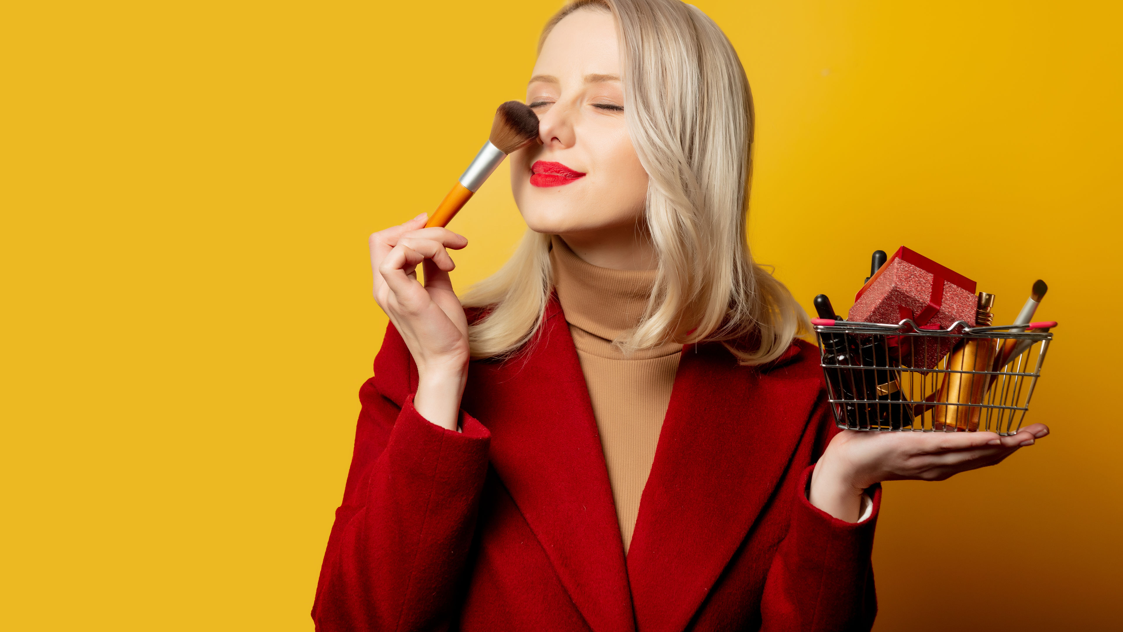 Woman in red coat with cosmetics 