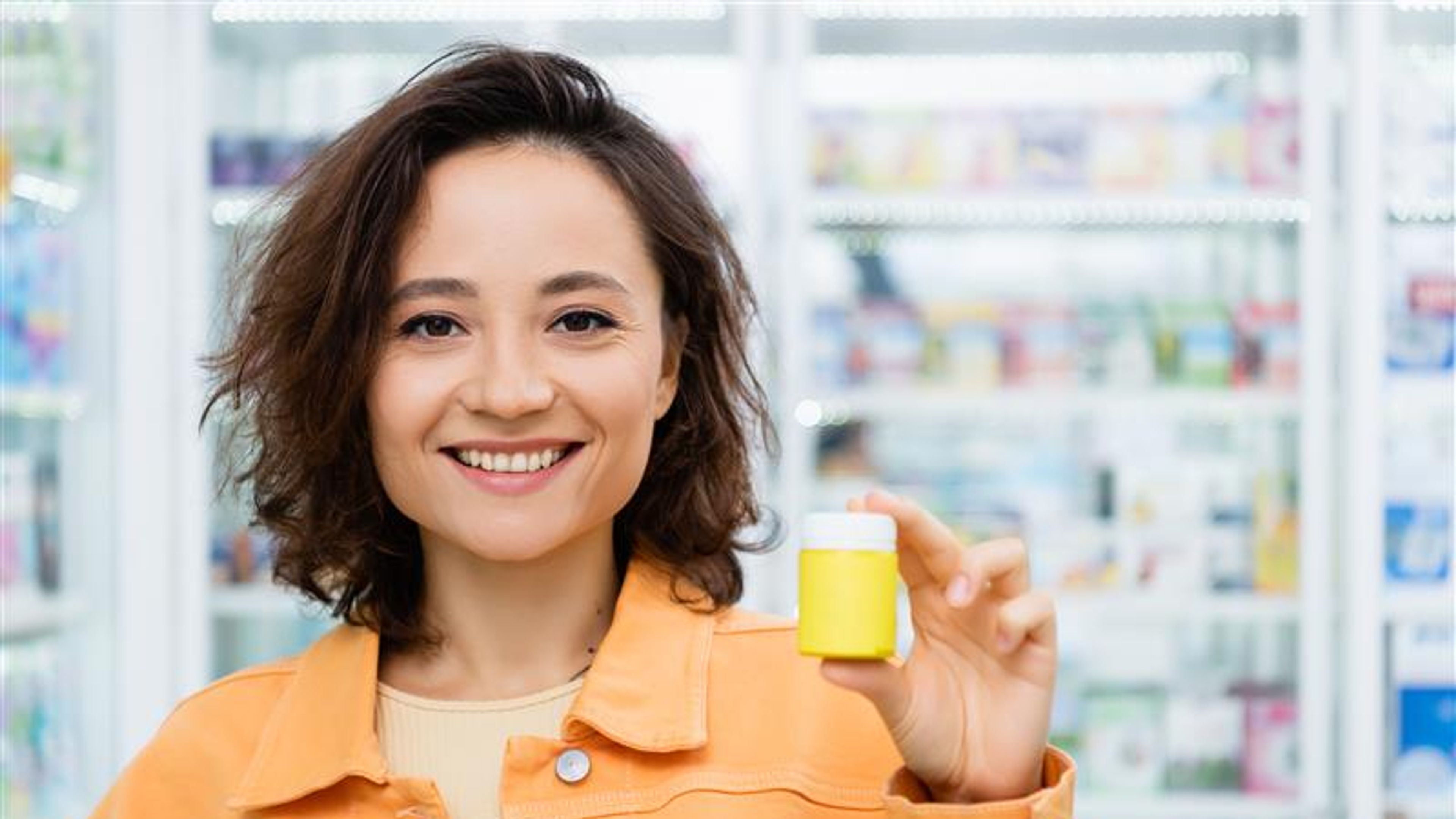 Woman smiling holding a bottle  