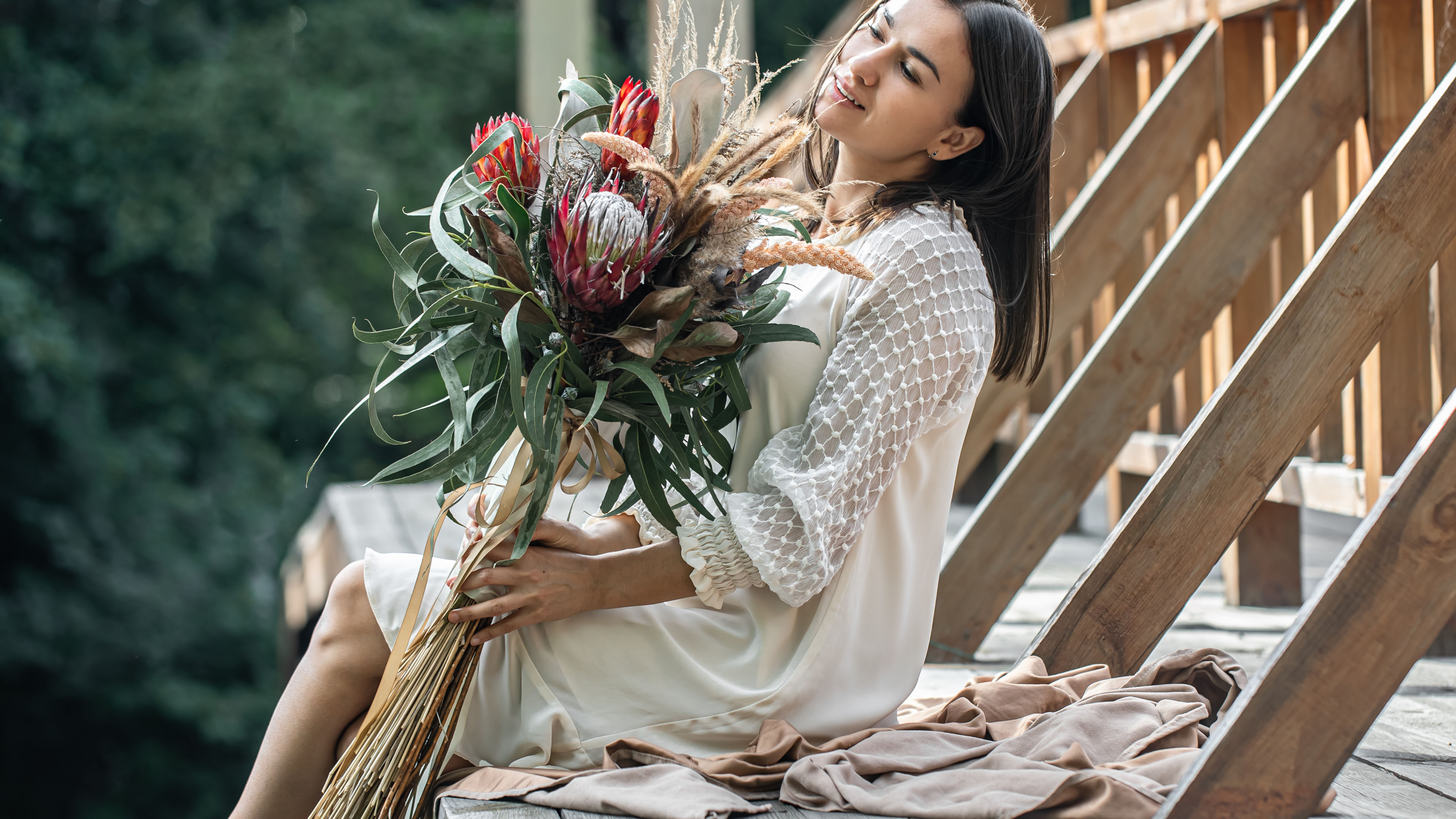 Portrait of a young woman holding a bouquet. 
