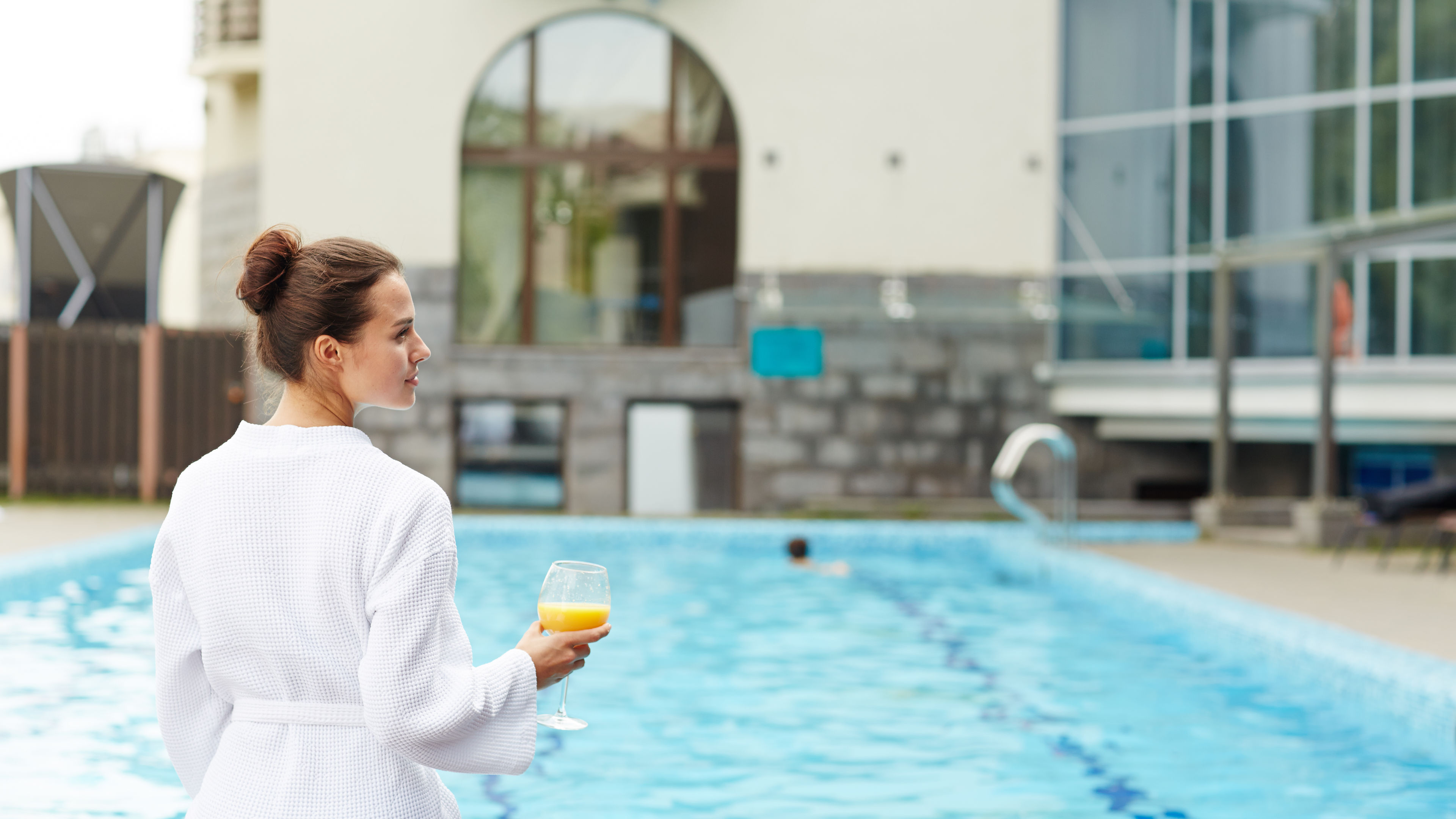 A woman is resting in the pool, enjoying the calm and relaxation. 
