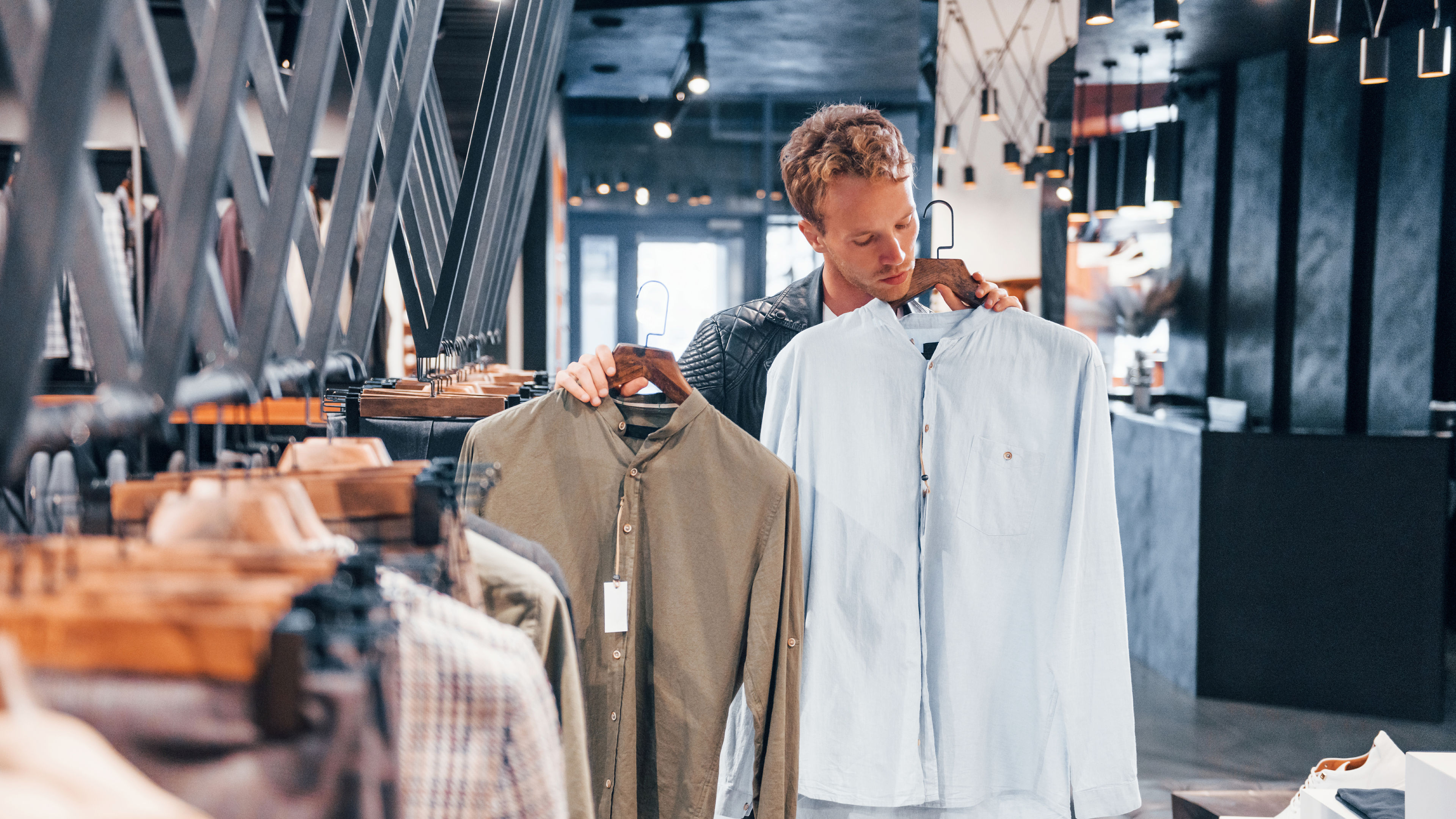 Young guy in modern store with new clothes