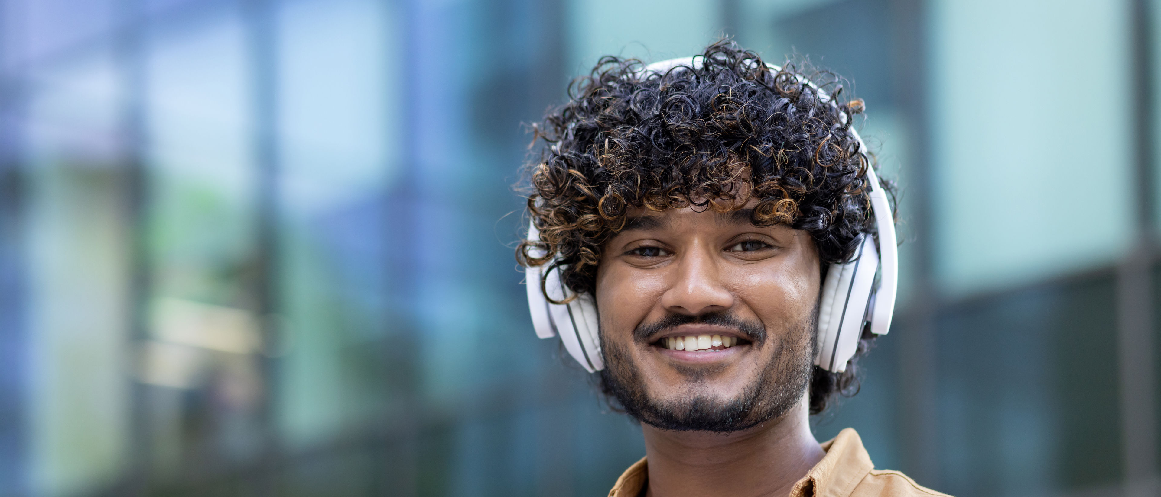 Young man listening music with new headphone