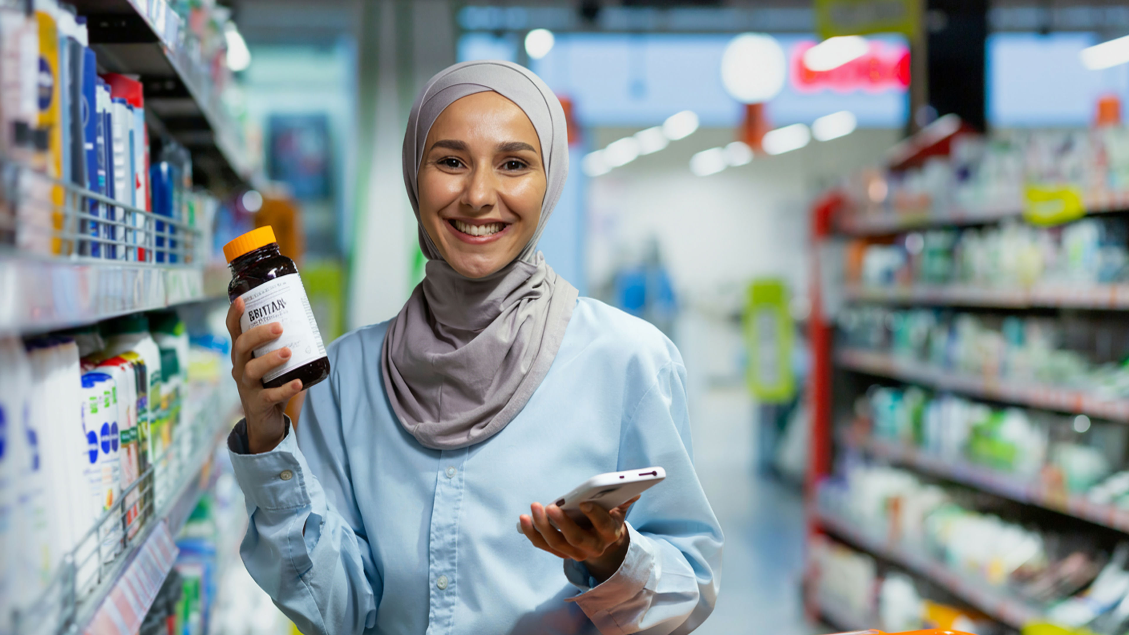 A young Arab woman in a hijab is standing in a supermarket.