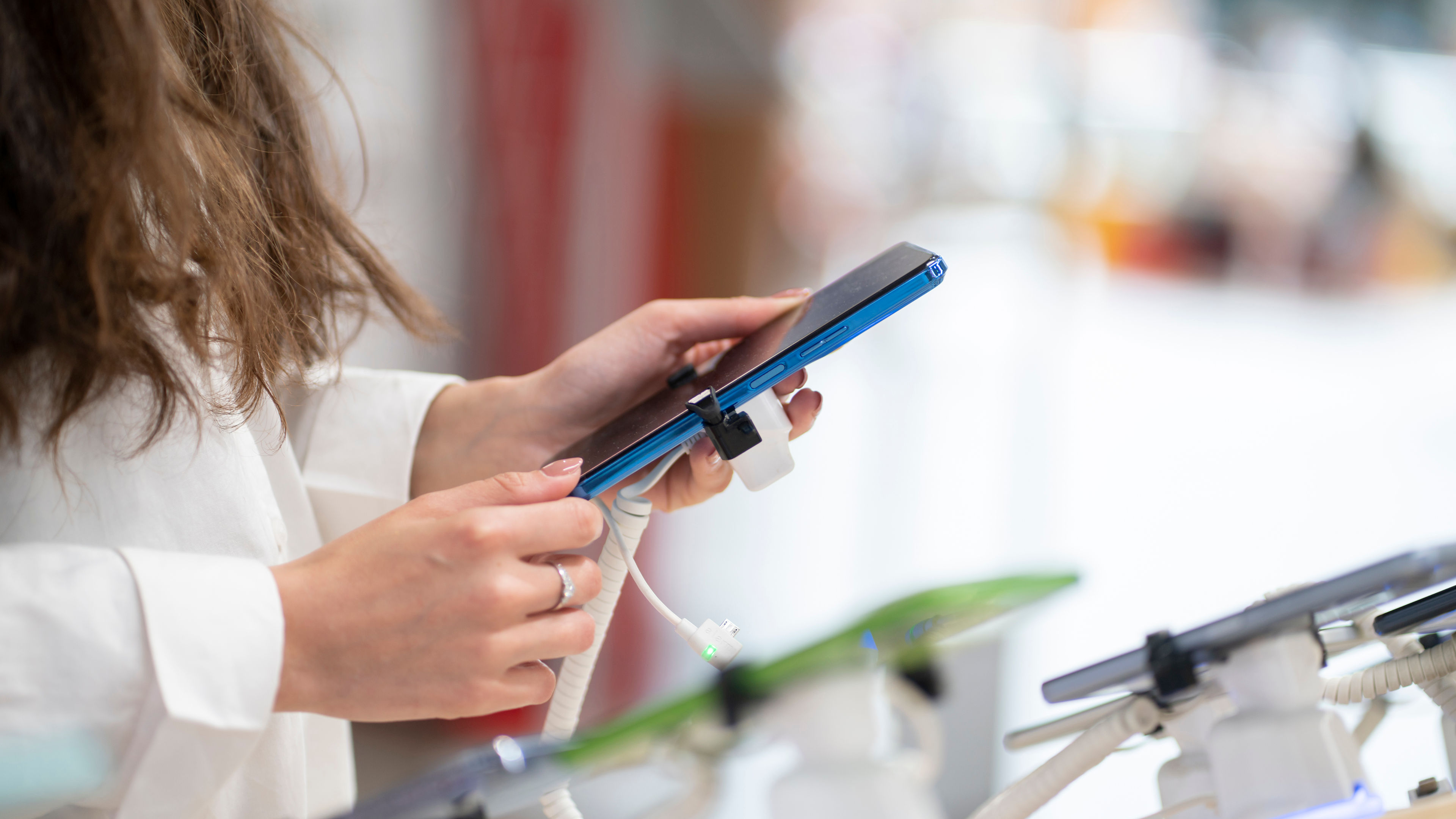 A woman is choosing items in an electronics store.