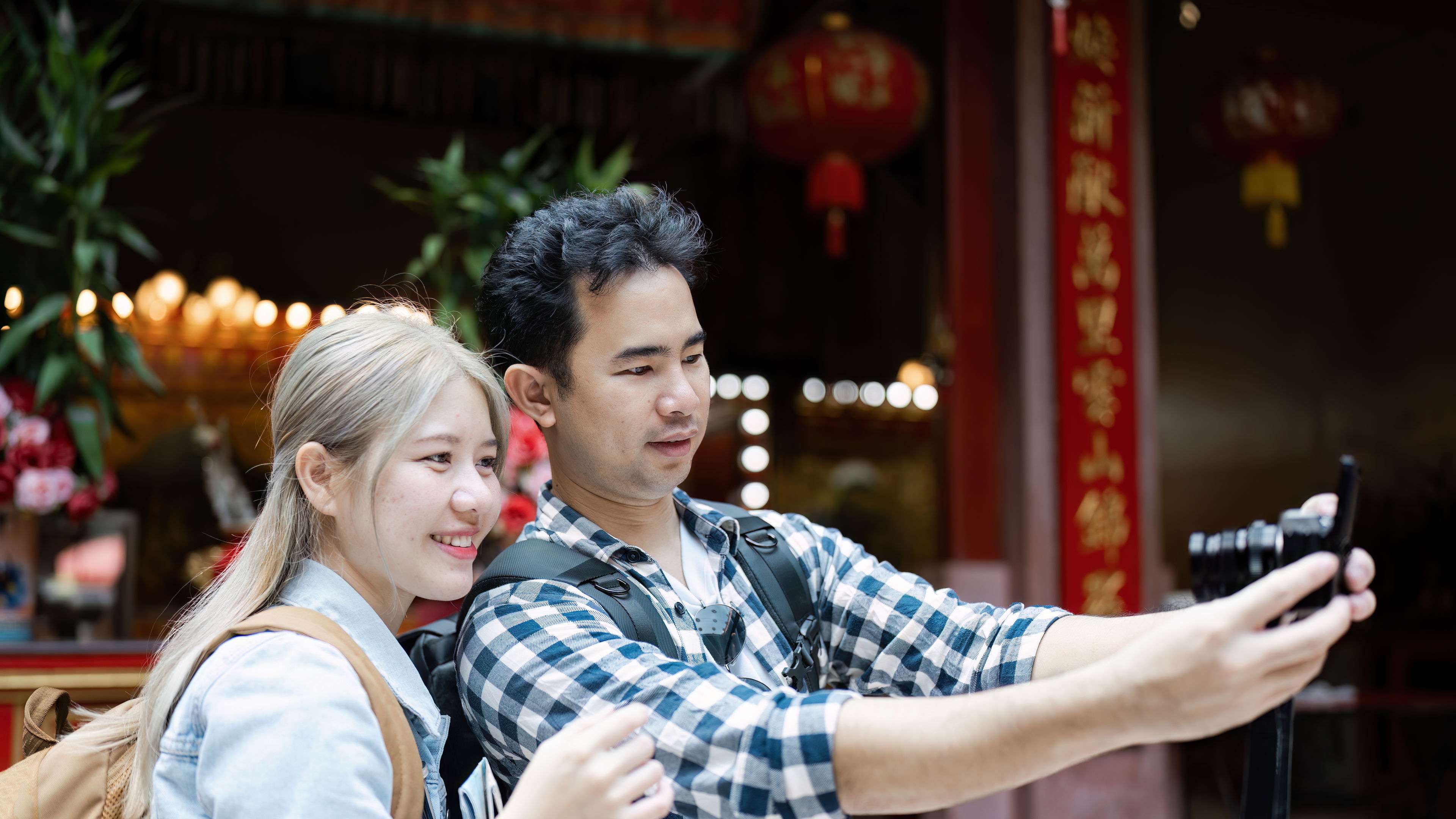 A happy couple taking selfie during a tour 