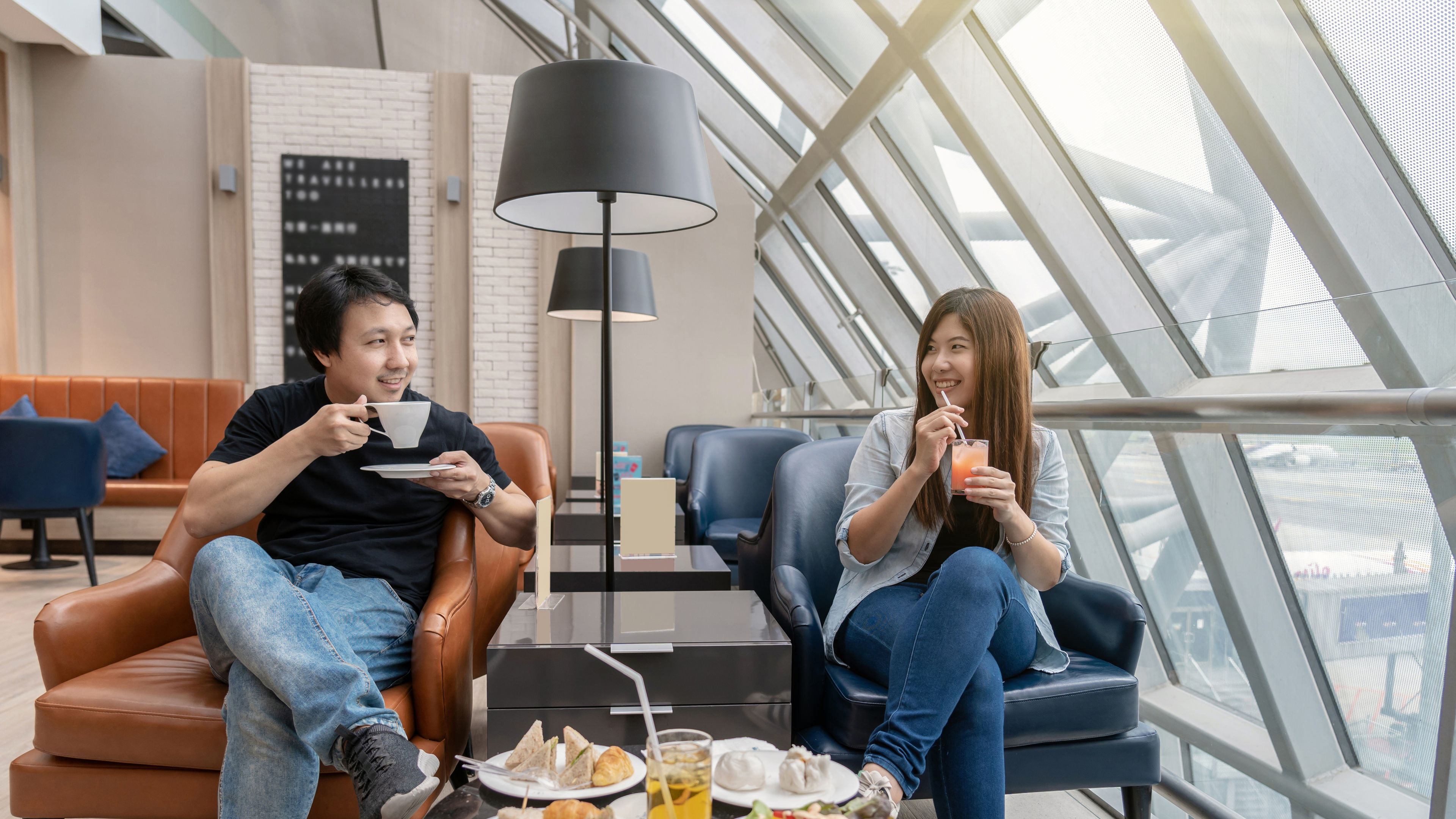 A happy man and a young woman having food in a hotel 