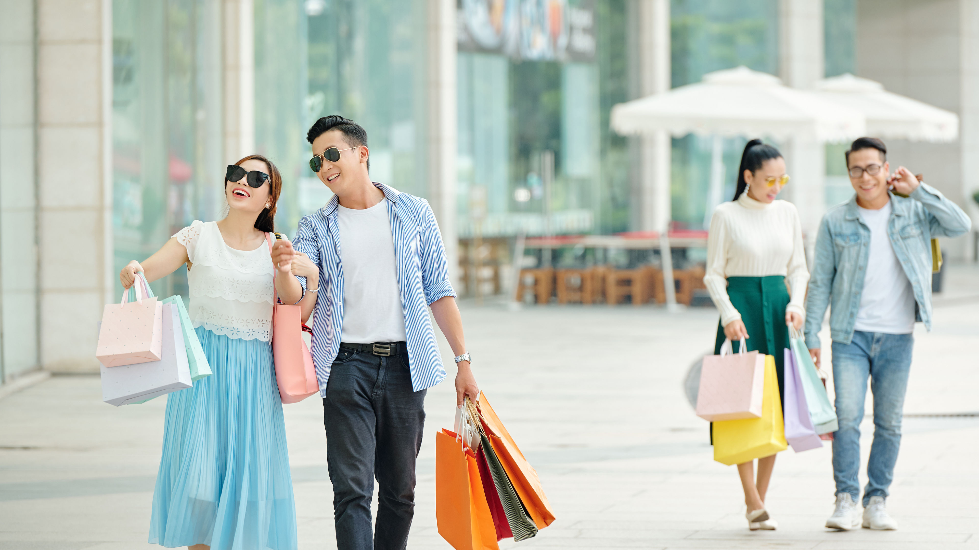 Asian couple walking in the street.  