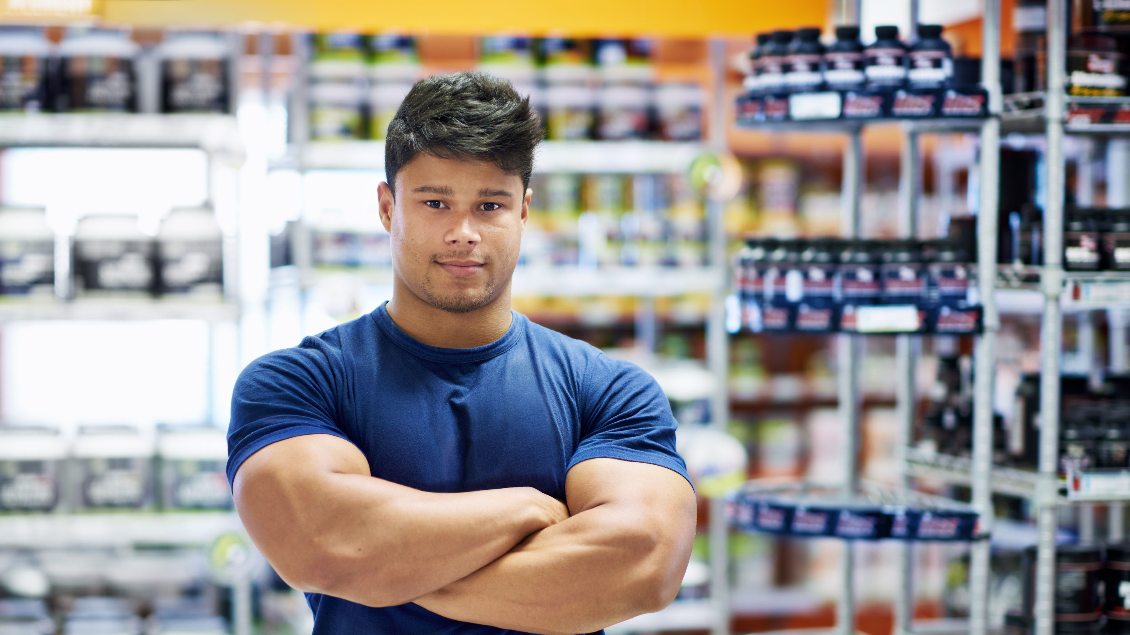 Asian Fitness Enthusiast Surrounded by Premium Protein Supplements 