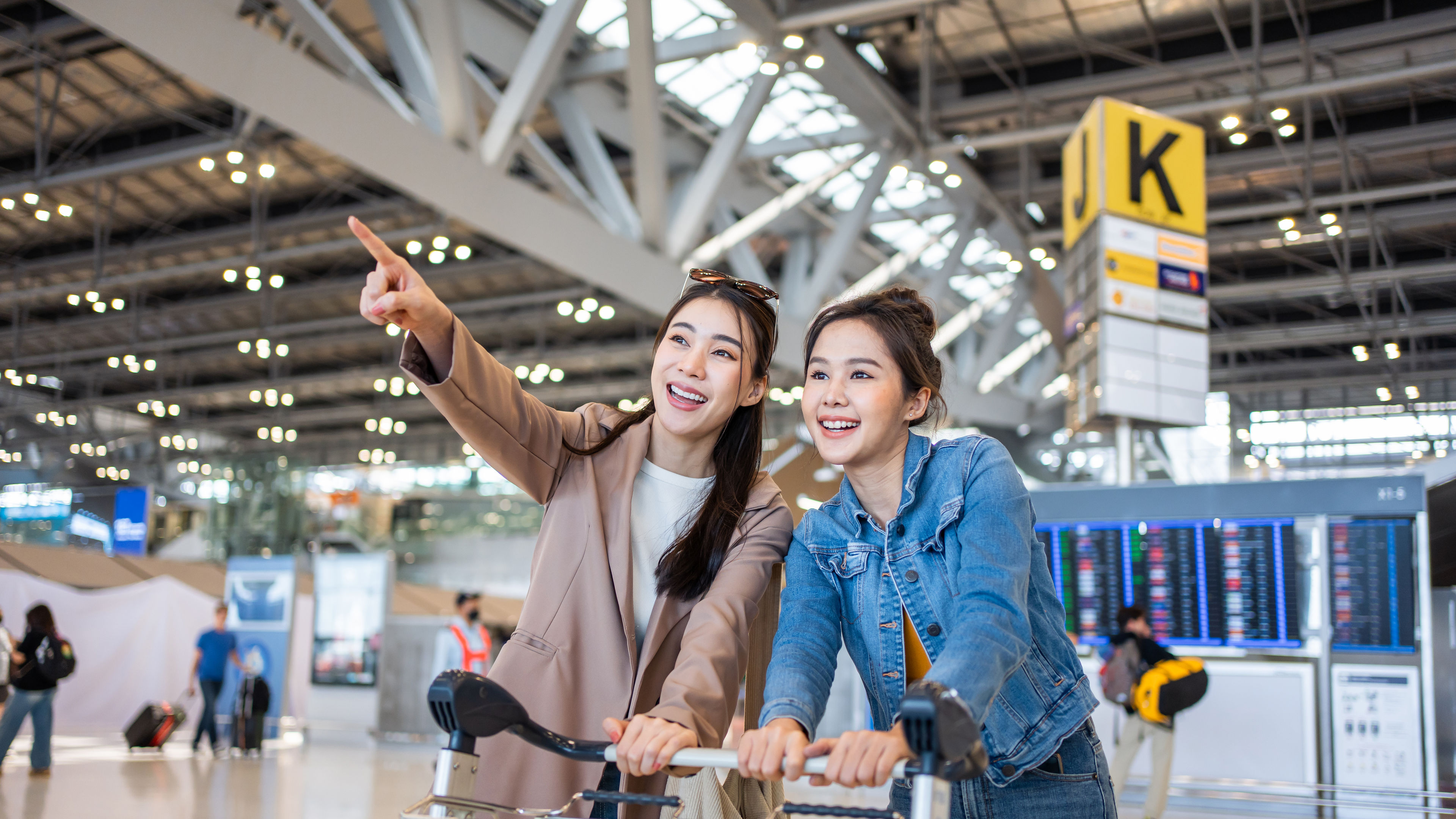 Asian young women passenger walk in airport terminal to boarding gate. 