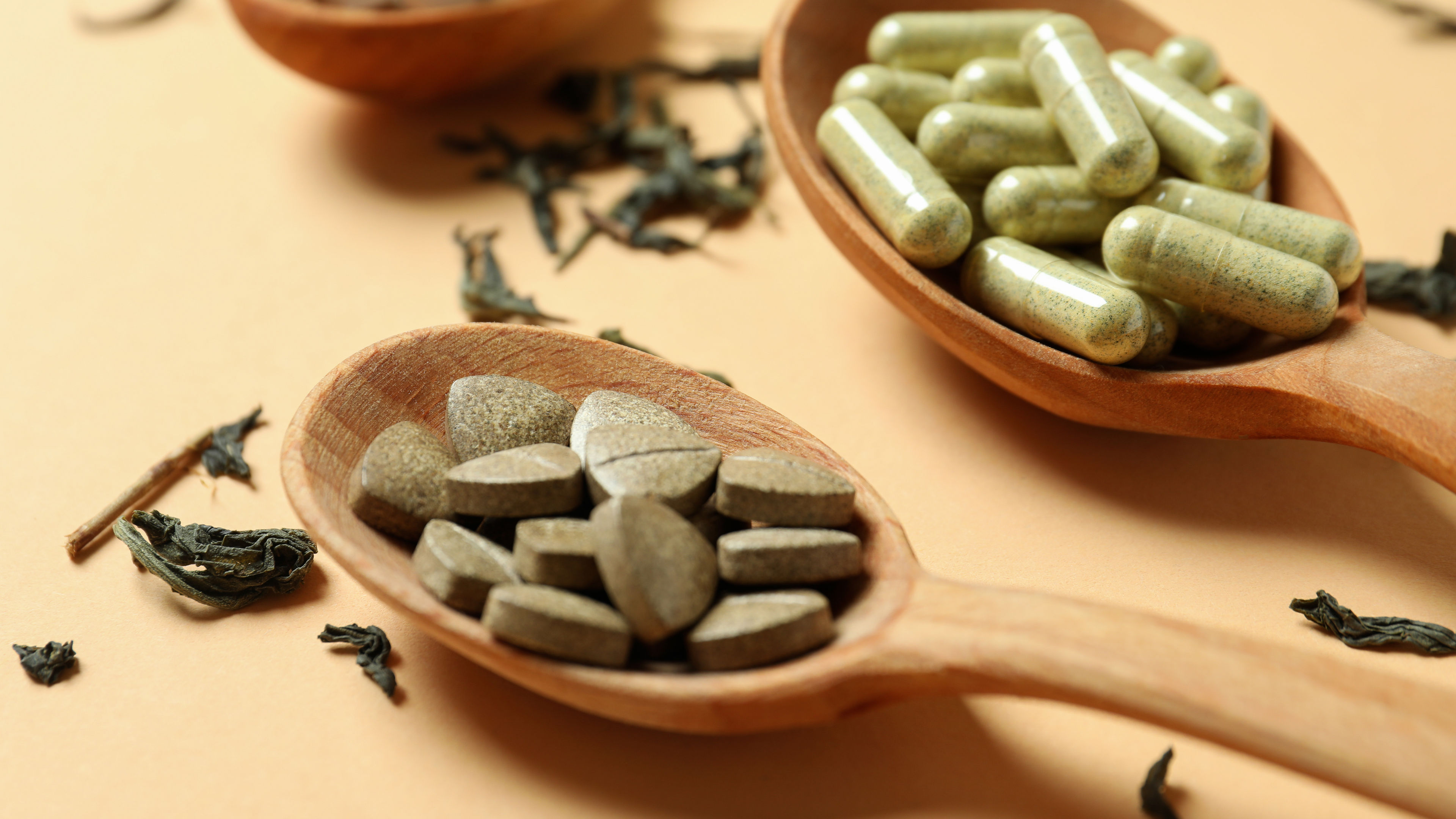 Concept of herbal medicine pills on beige background 