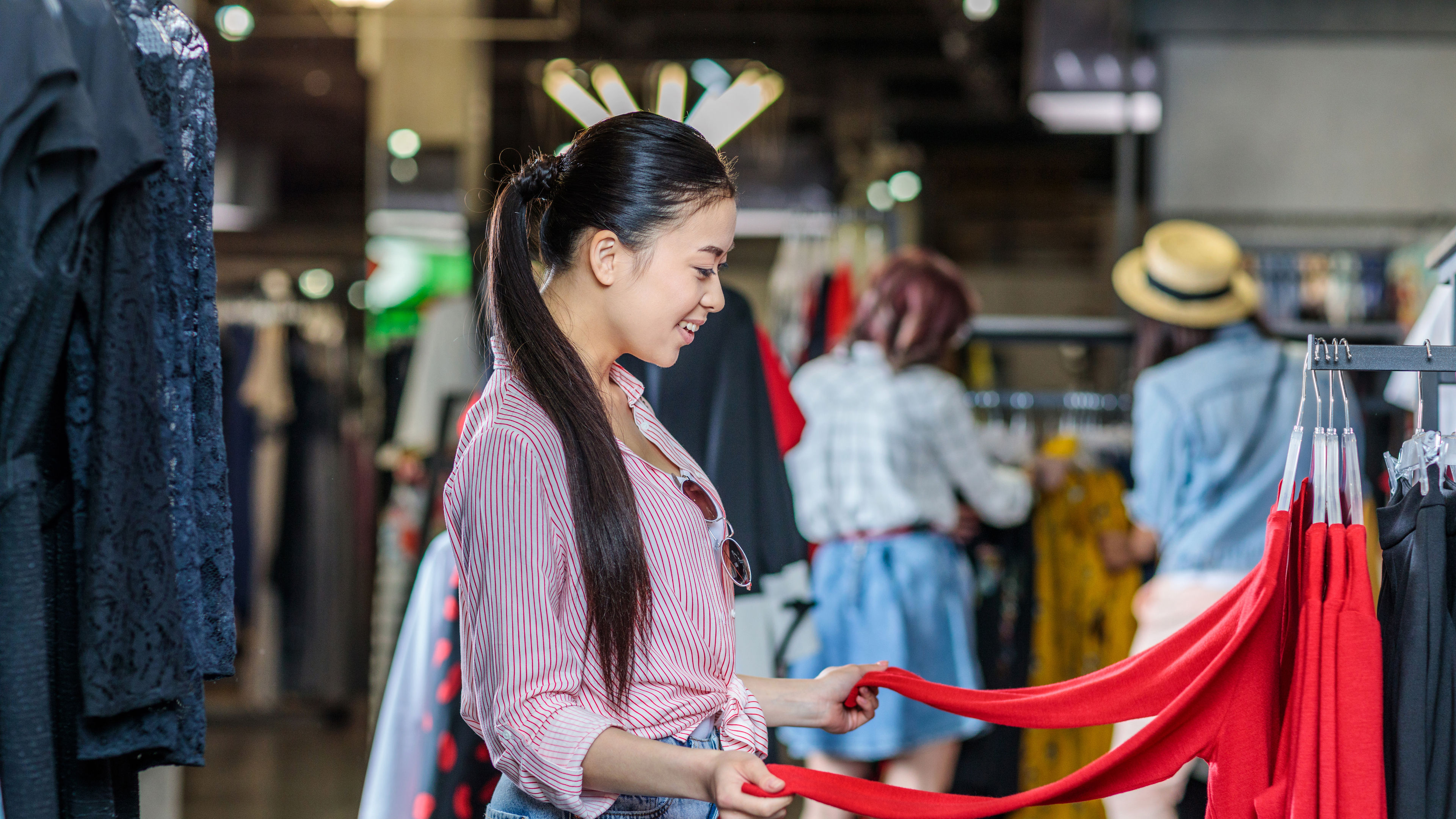 Image of a girl in jeans choosing clothes 