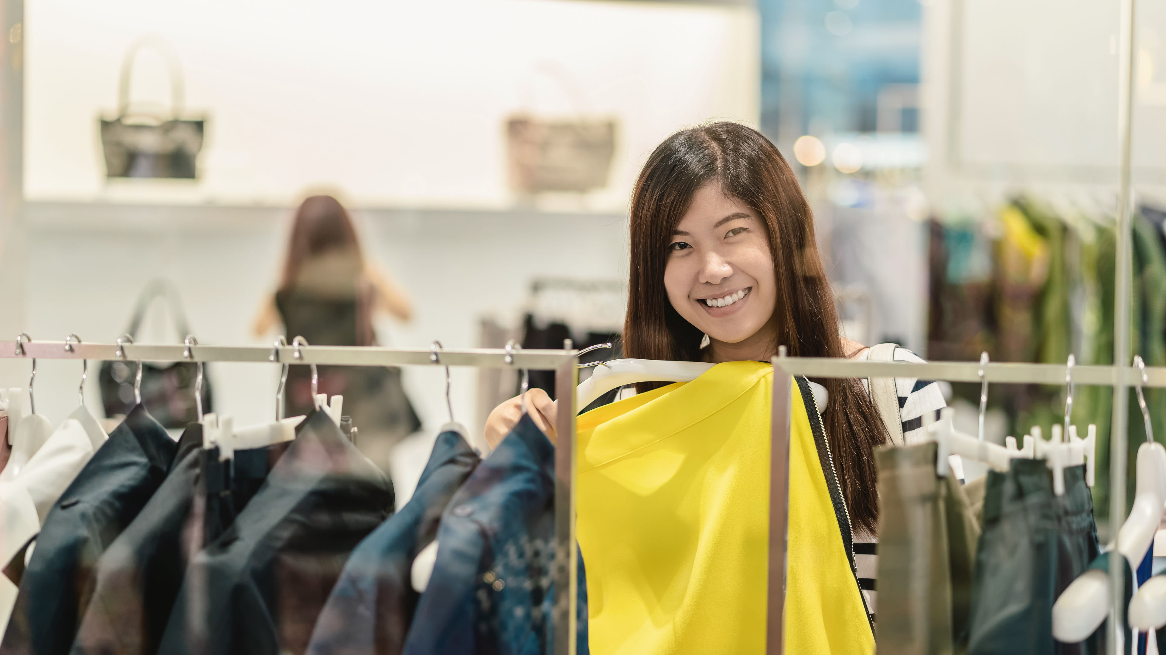 Image of a happy asian woman choosing