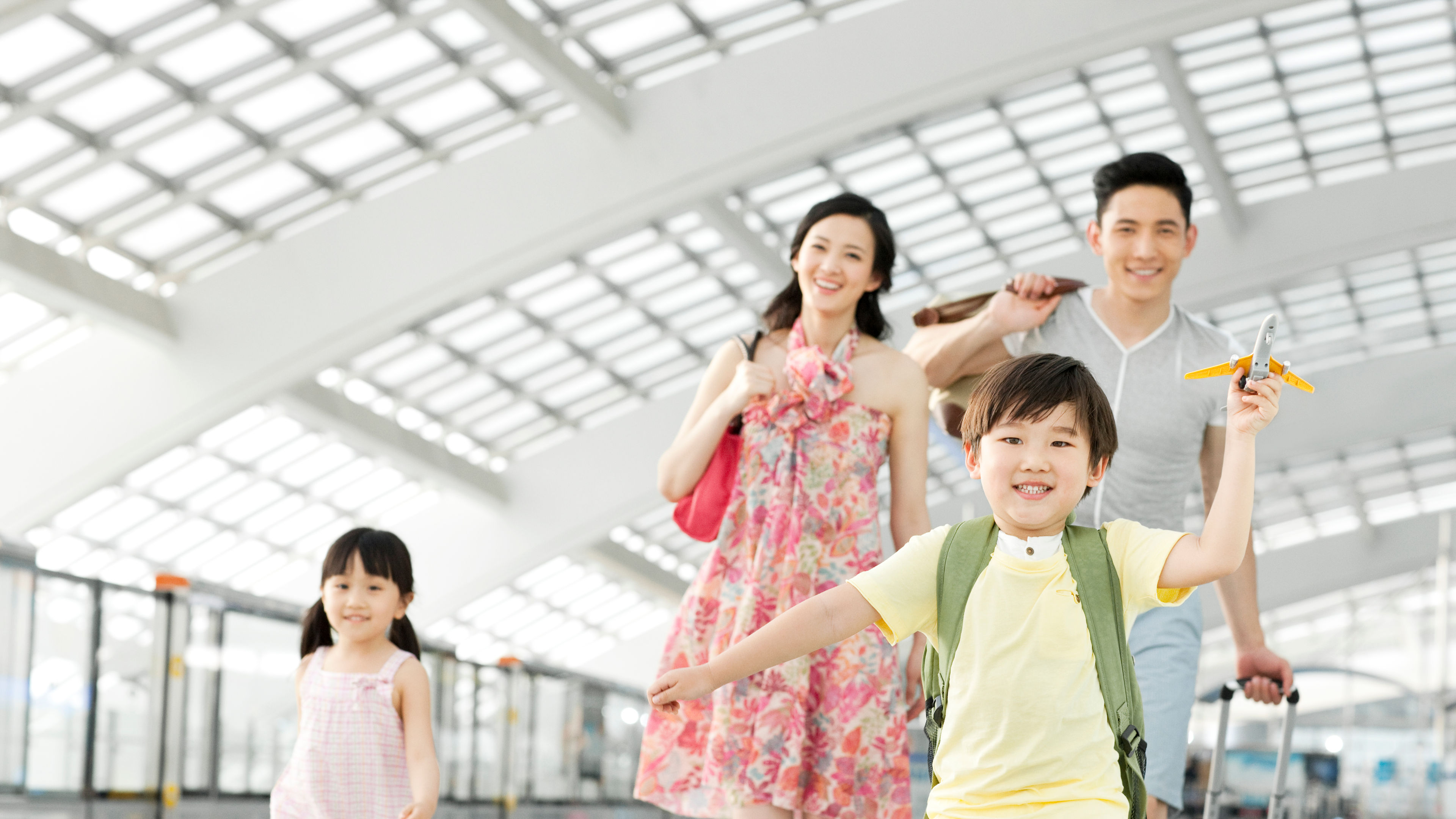 Happy family with luggage at the airport 