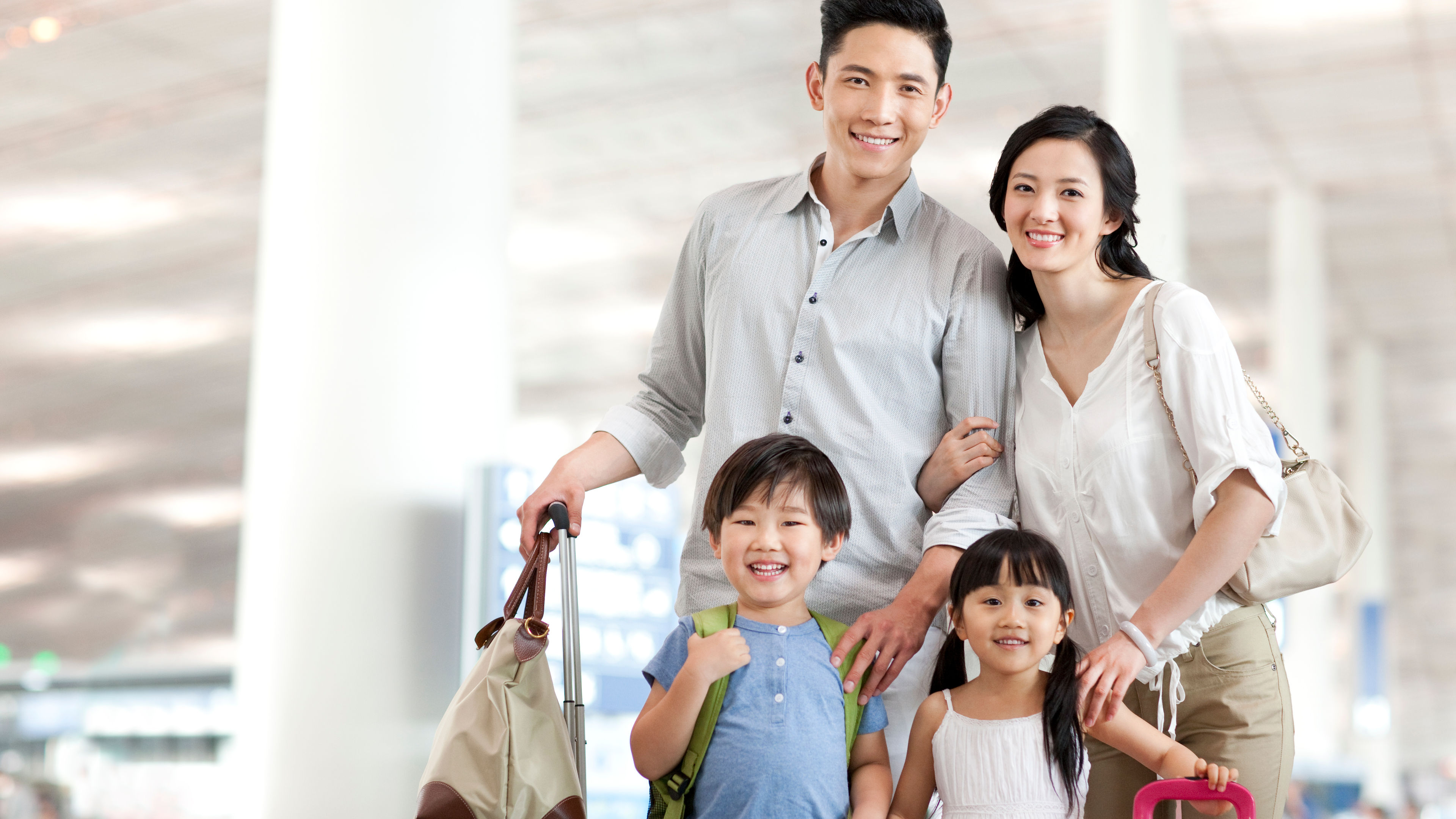 Happy young family at the airport 