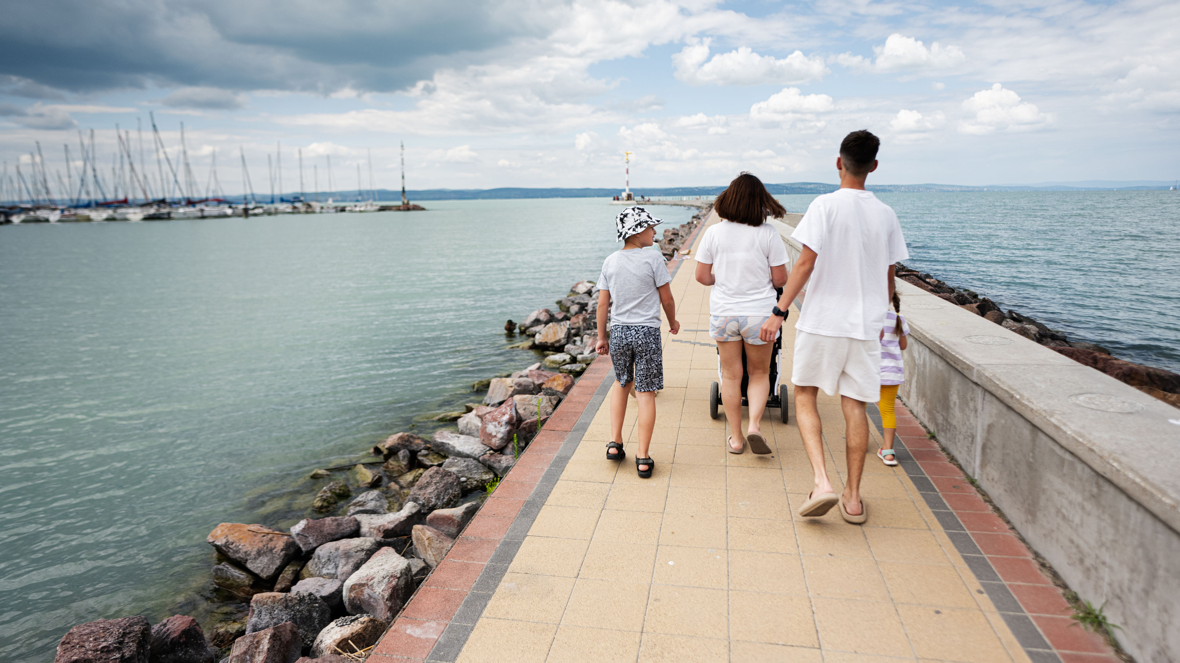 A family of four walking on the pier 