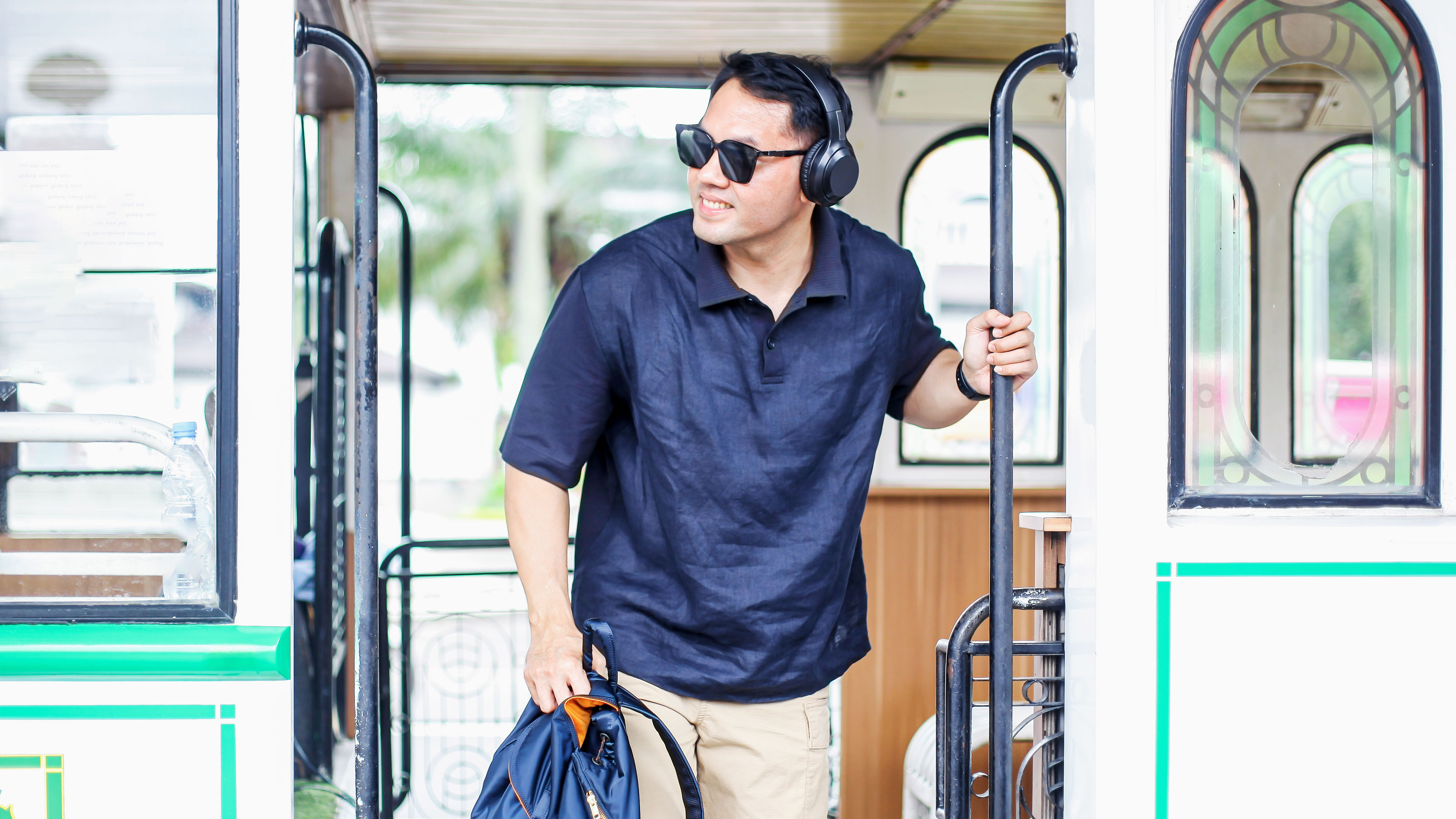 Man wear headphone getting of the bus