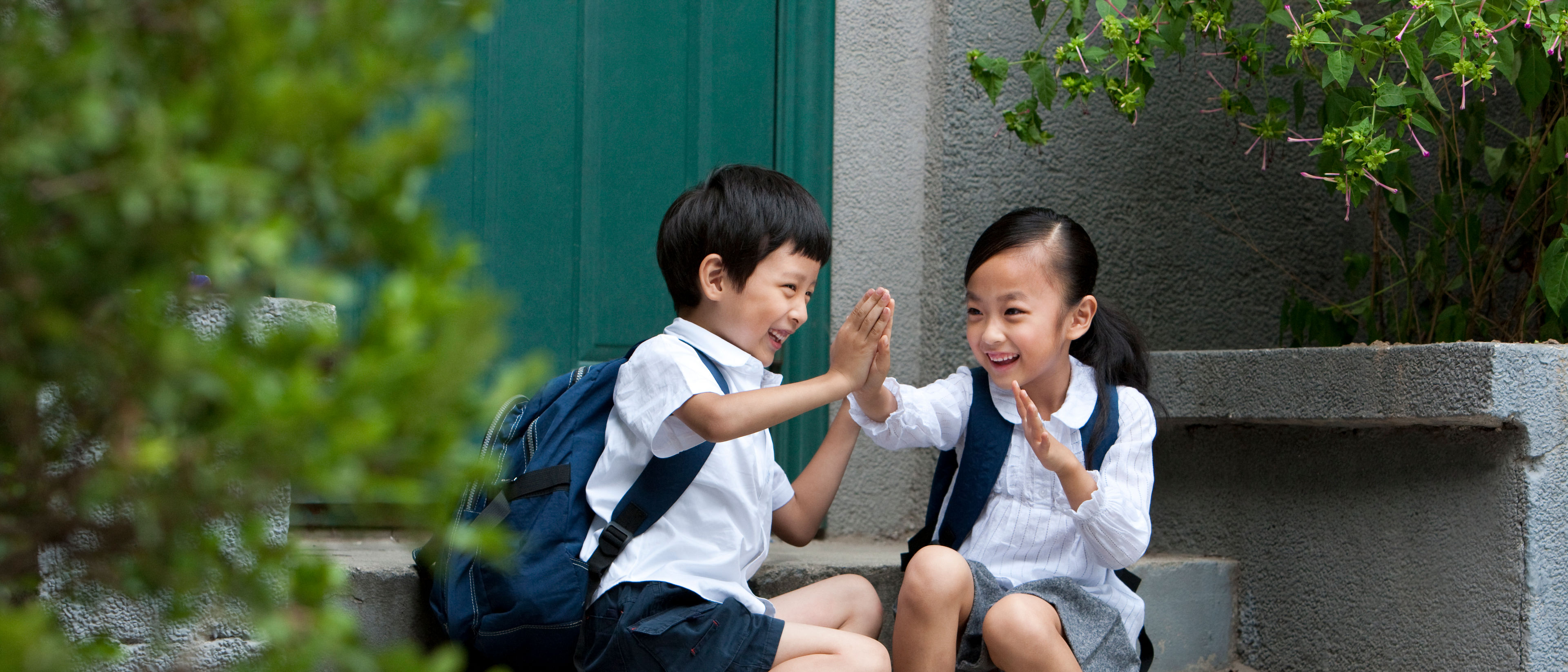 Two school children playing outside.