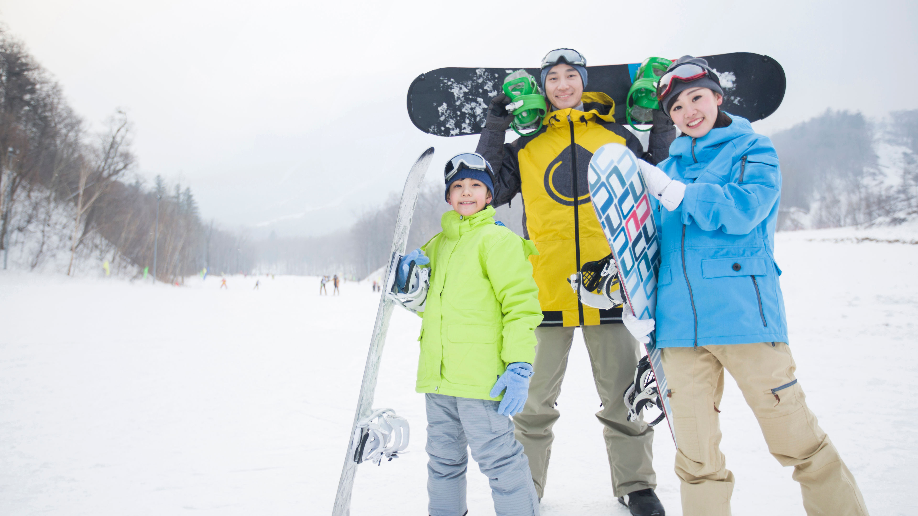 Young family with snowboards 