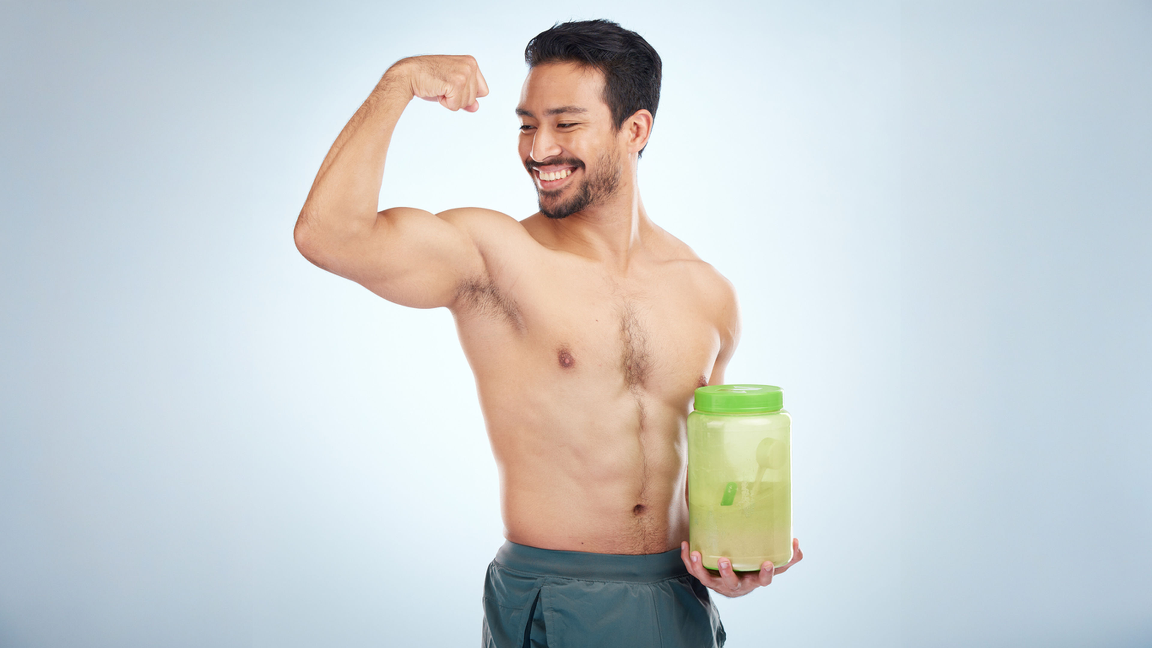 An Indian bodybuilder with protein supplement in hand.