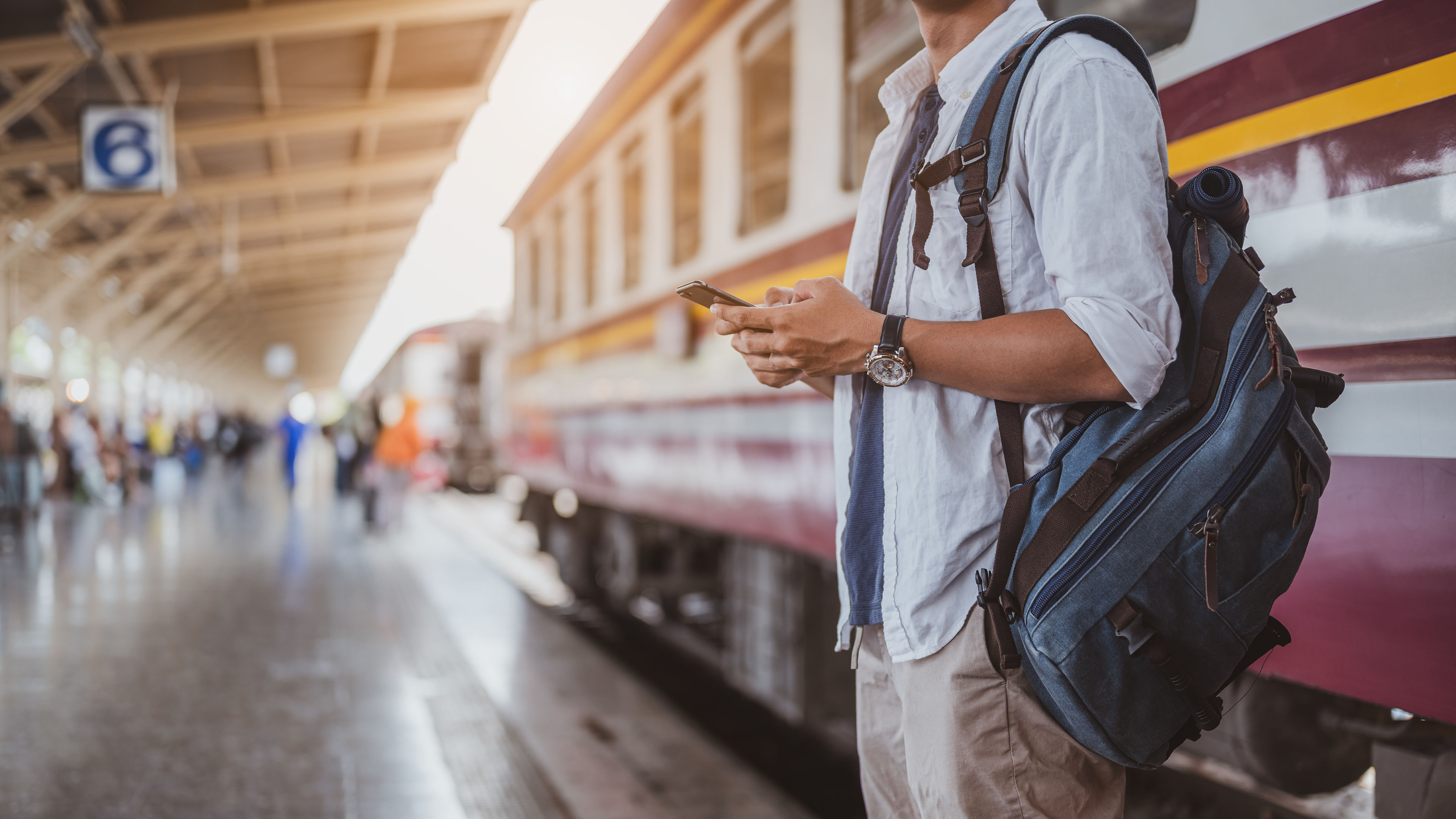 Asian man returning from a vacation on a train journey.