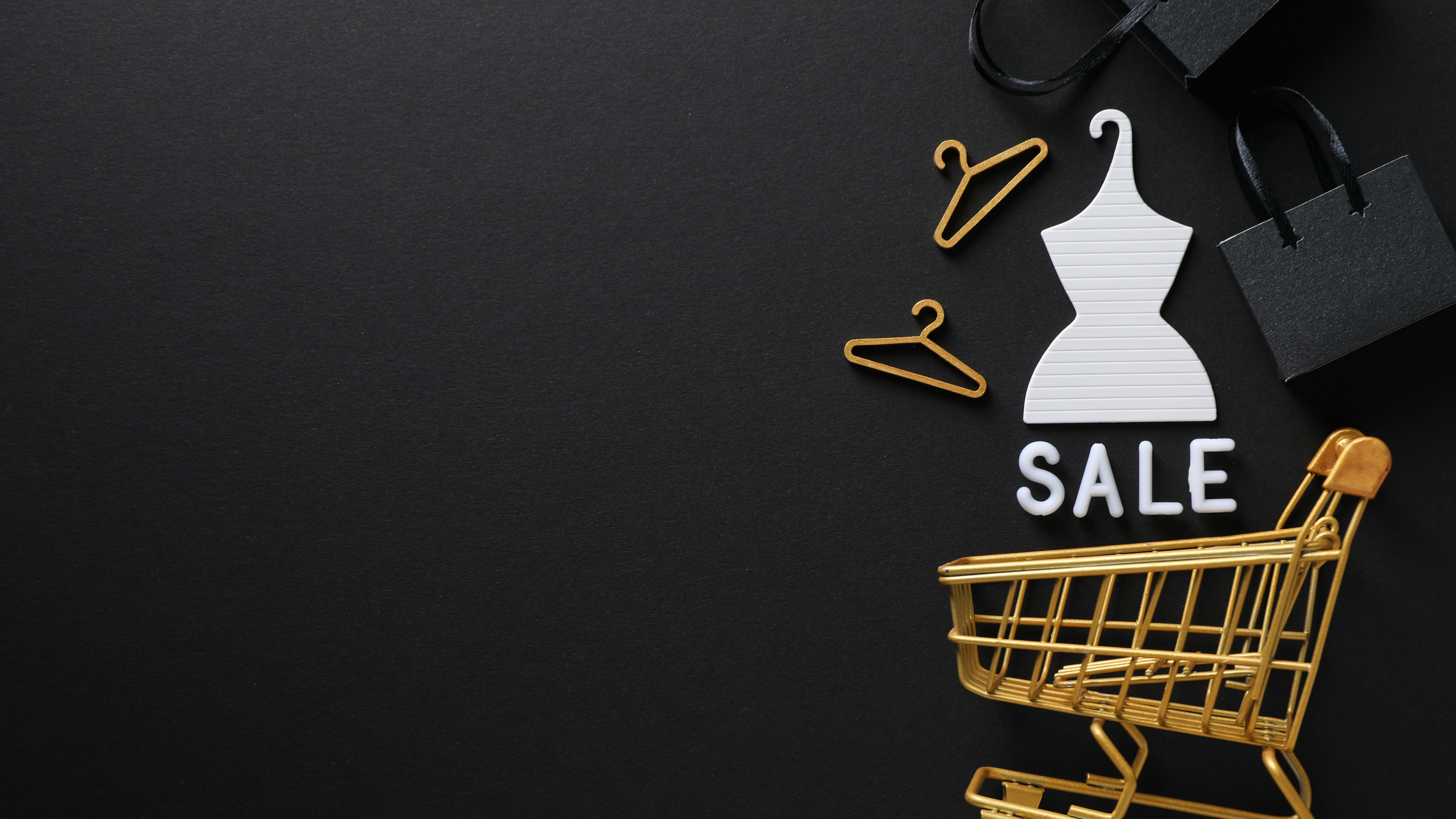 A shopping cart with a sale board behind 
