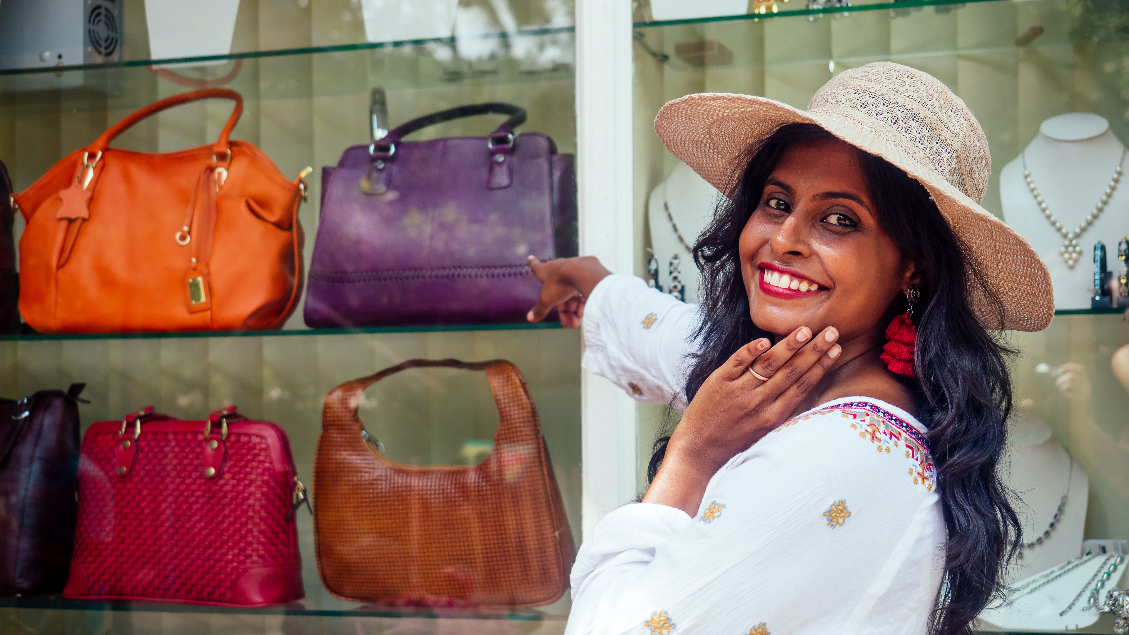 A happy woman with some bags behind 
