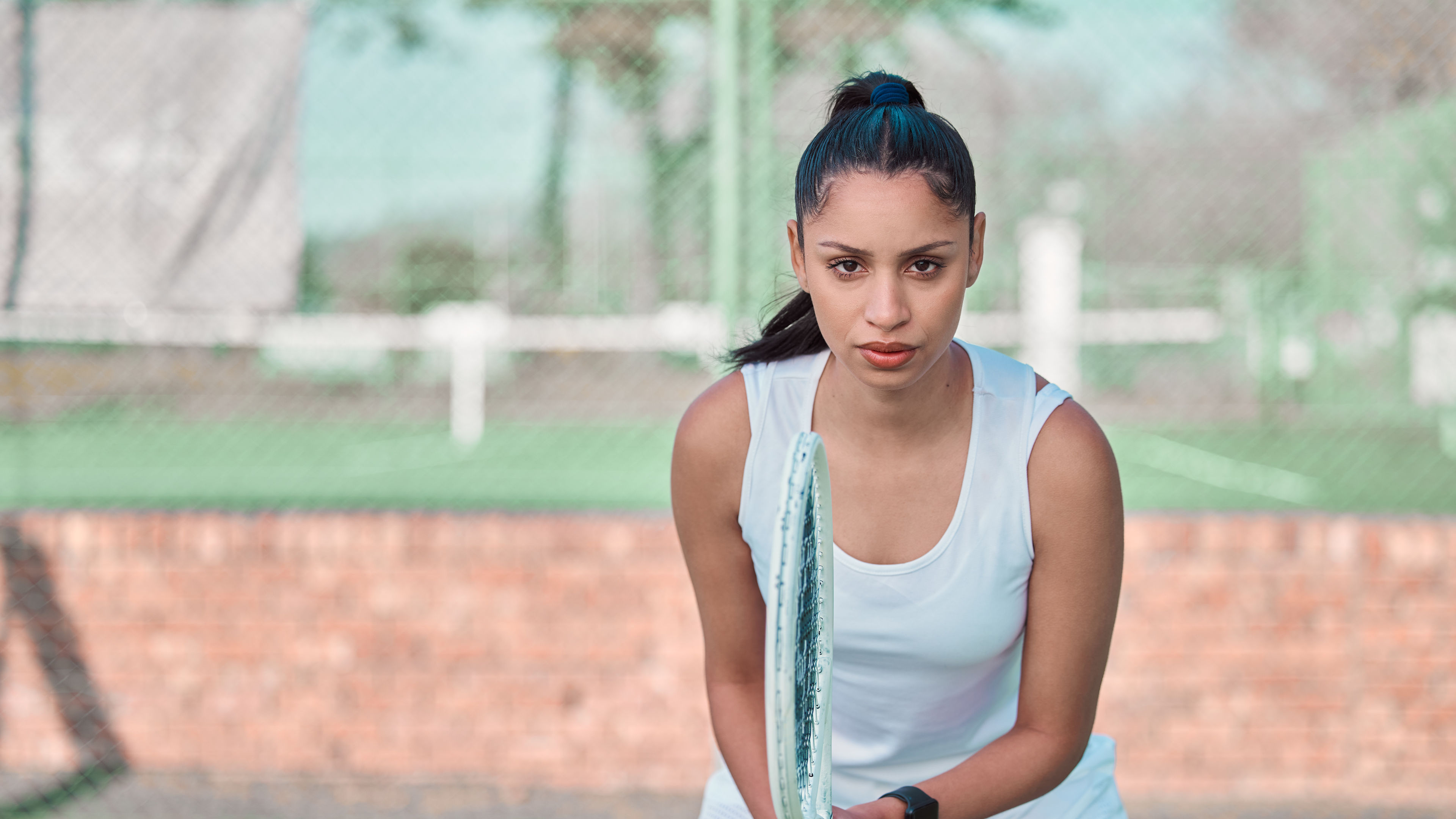 A determined tennis player intensely focused and ready for action on the court