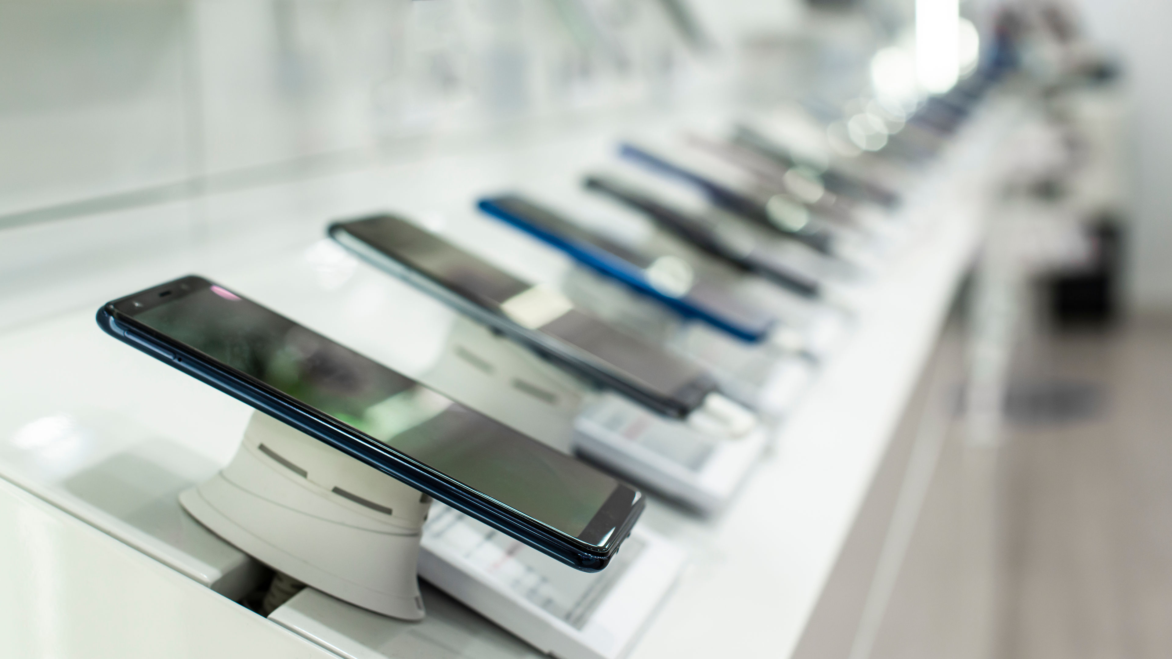 Some smartphones on a shelf in the store 
