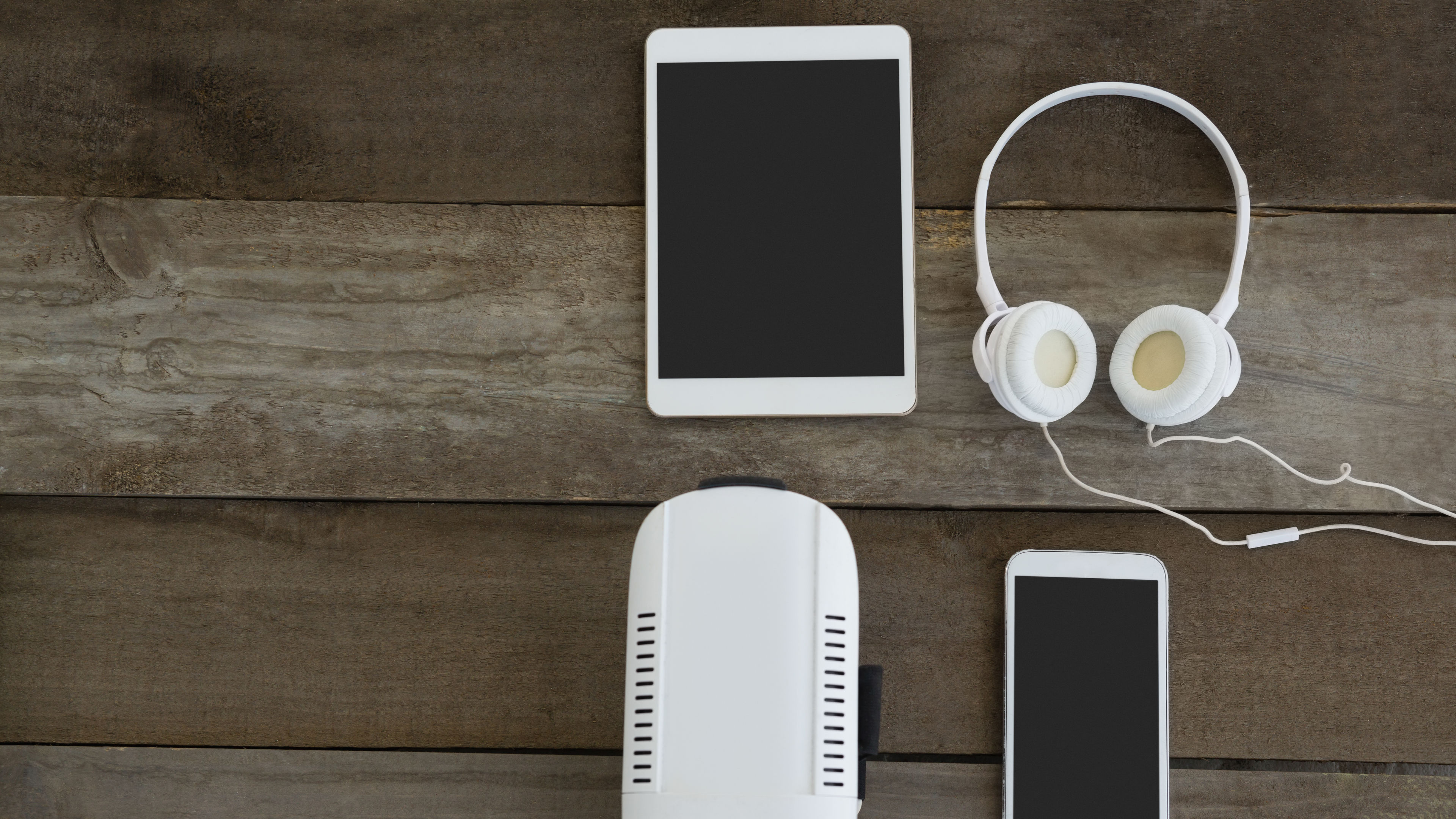 Various electronic gadgets on wooden surface 