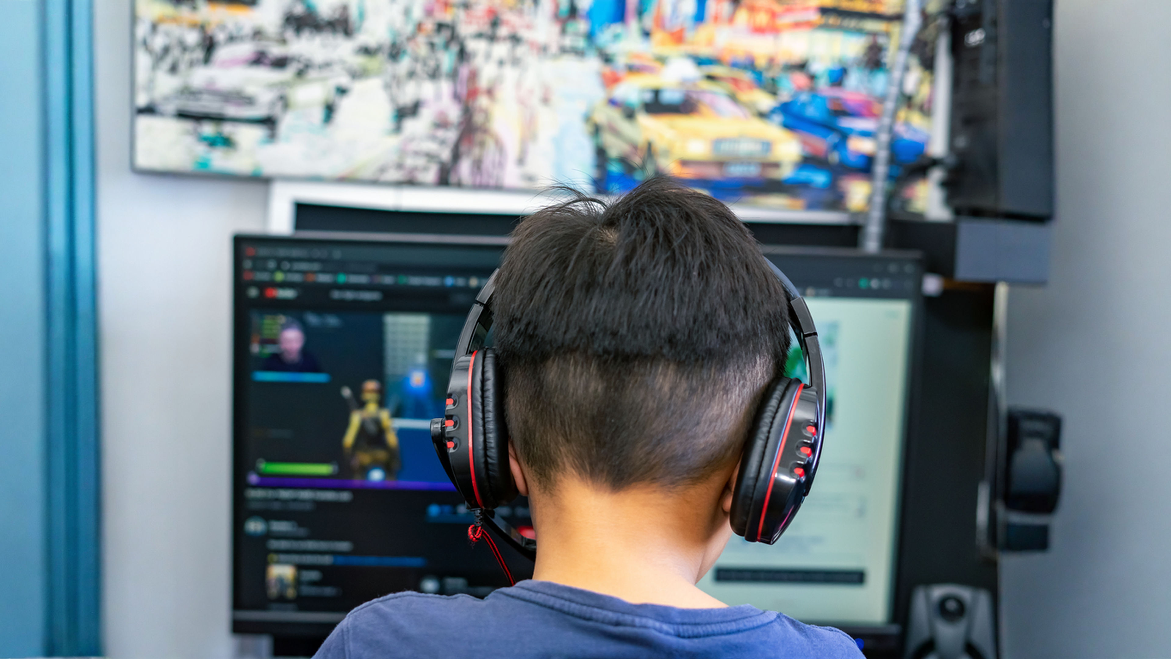 A gamer or a streamer boy at home in a room playing with friends on the networks.