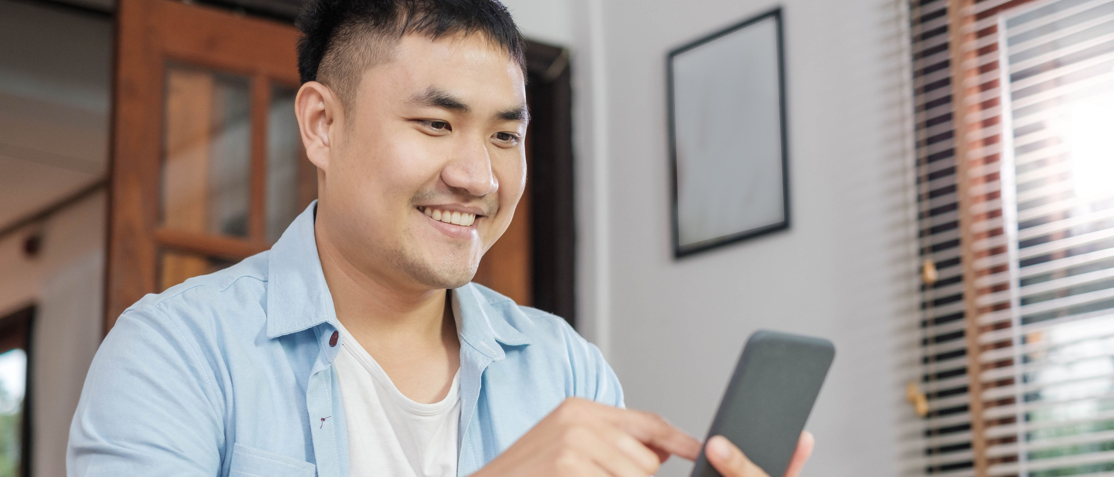 Happy man using mobile phone