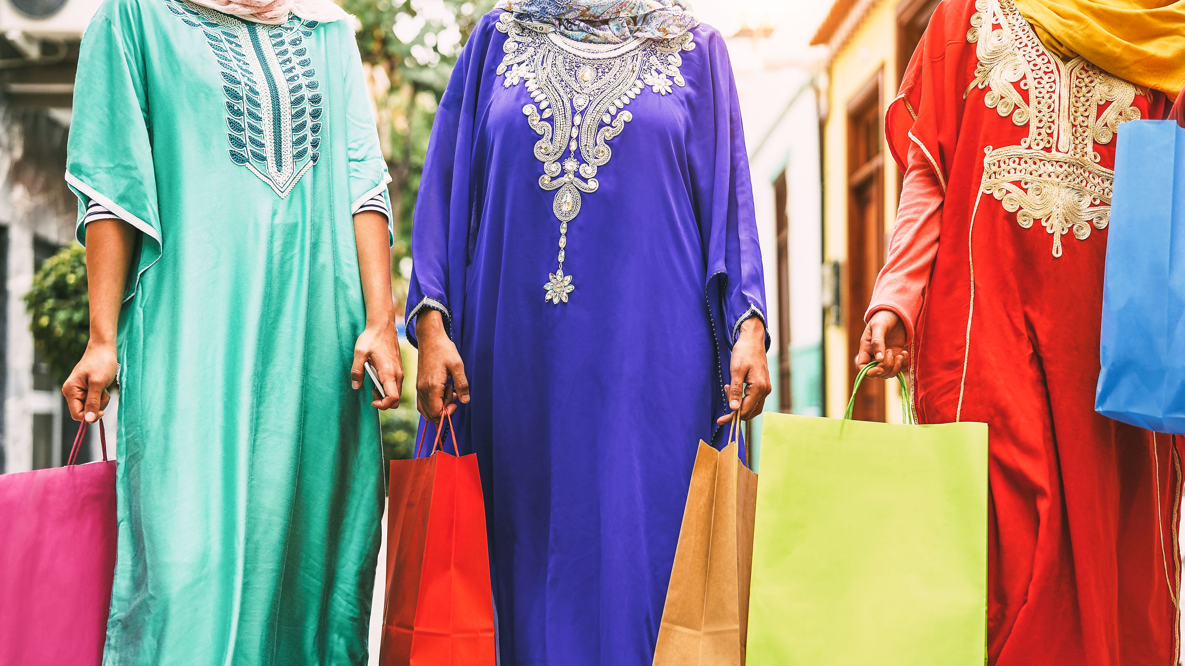 Happy Muslim women doing shopping in the city center