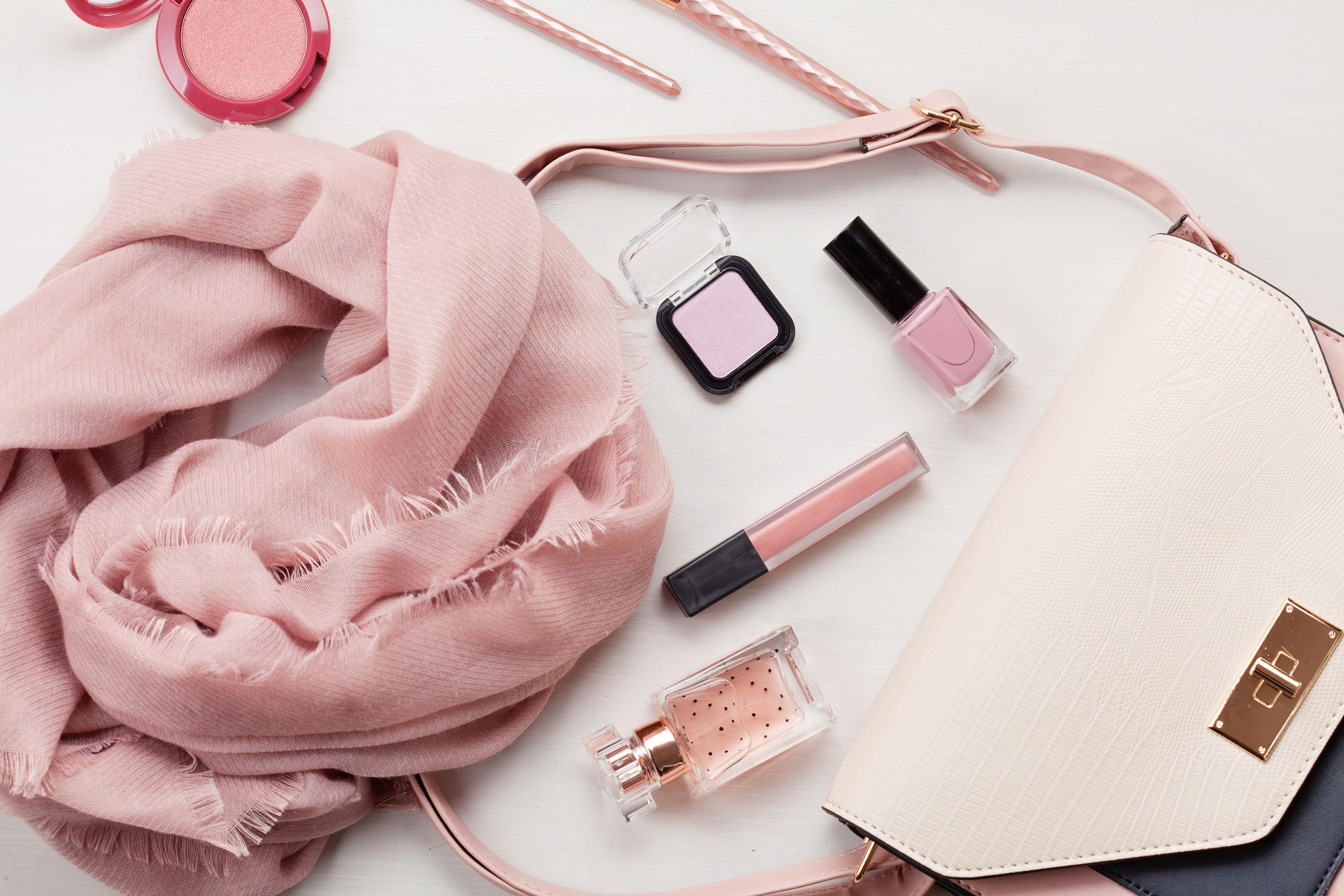 Flat lay arrangement of pink fashion accessories