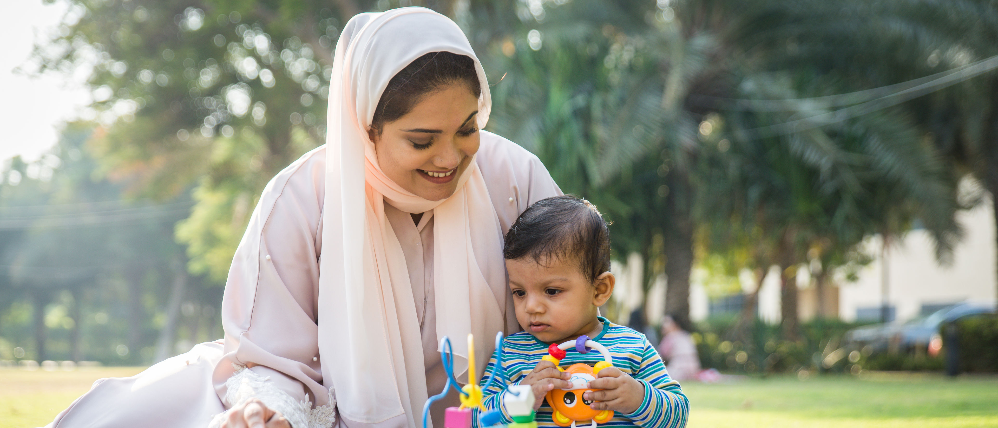 mom and her little toddler playing outdoors 