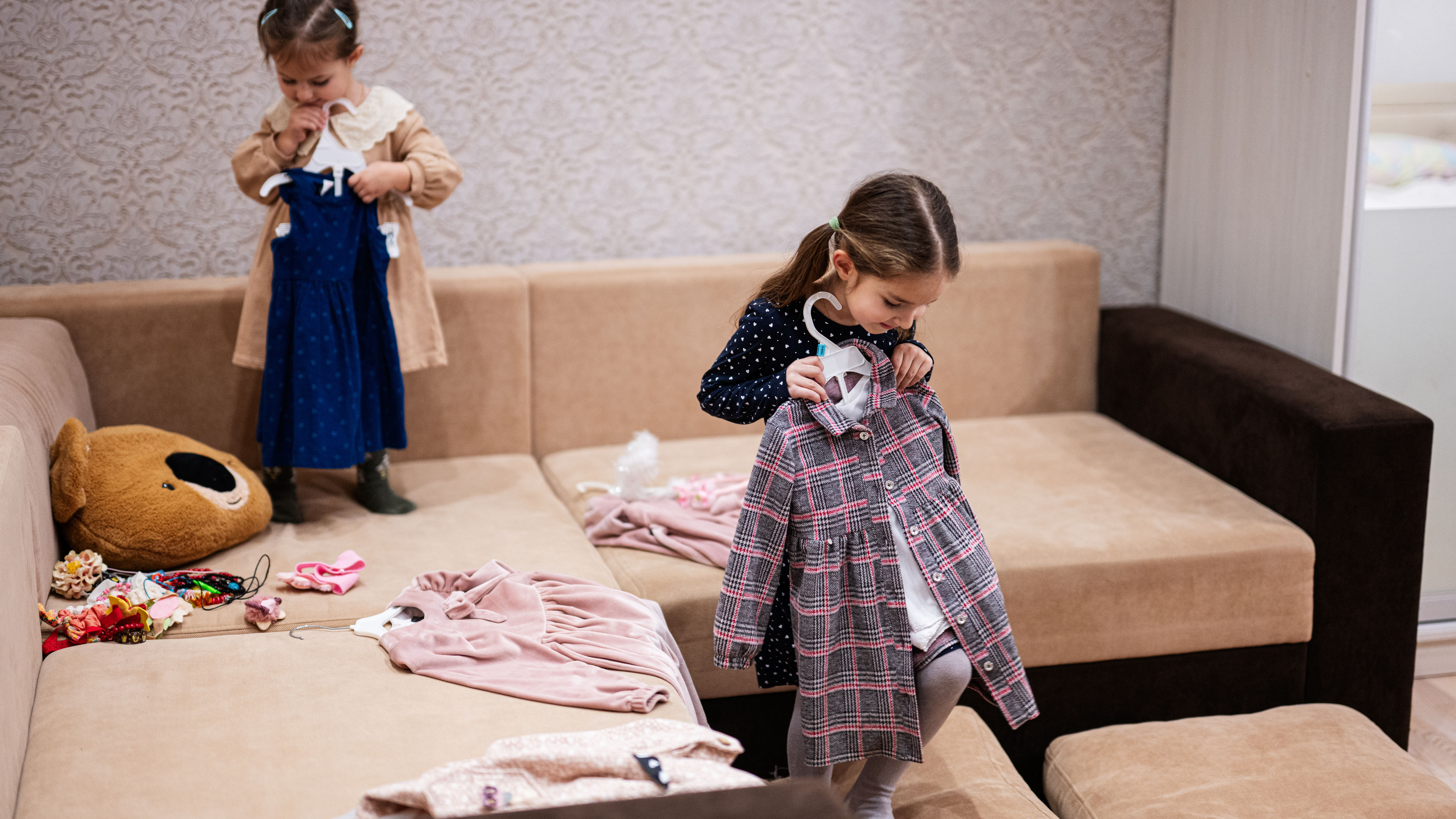 Sisters choosing clothes from the wardrobe