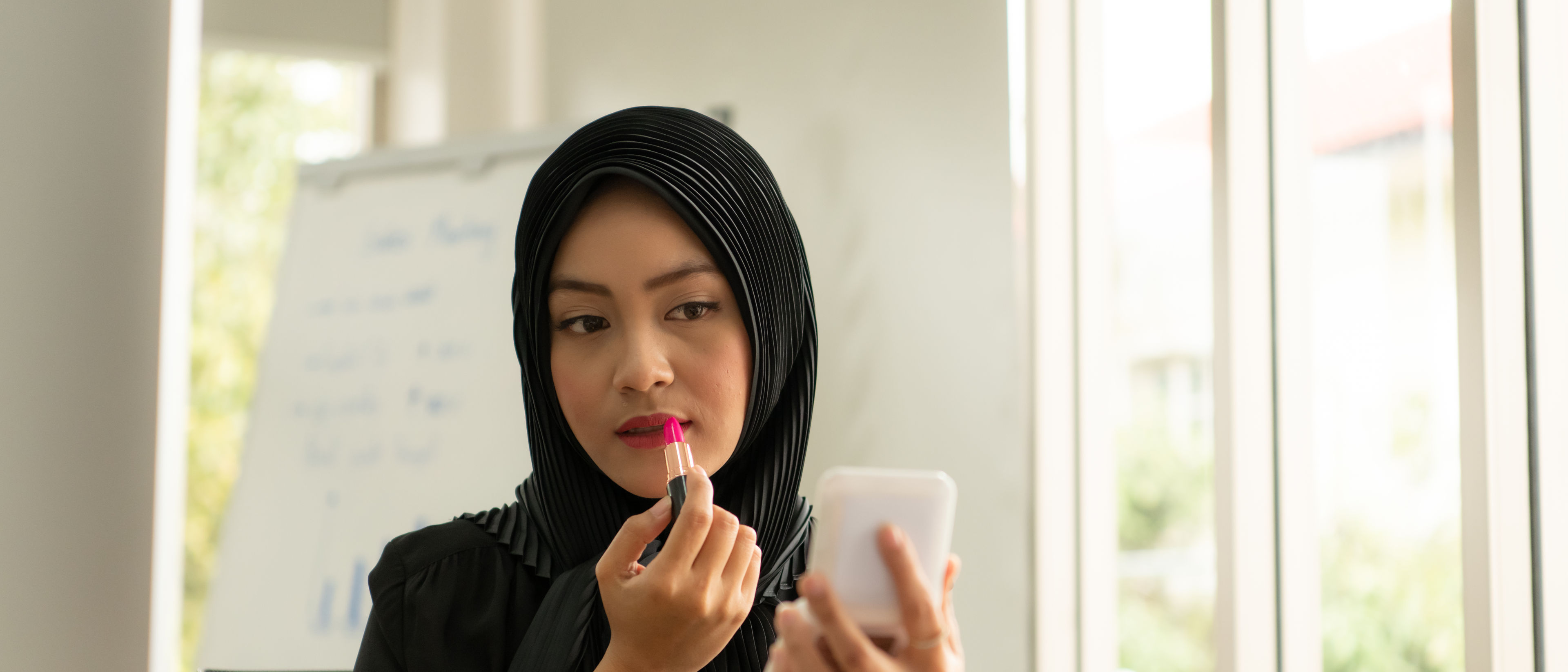 woman applying lipstick