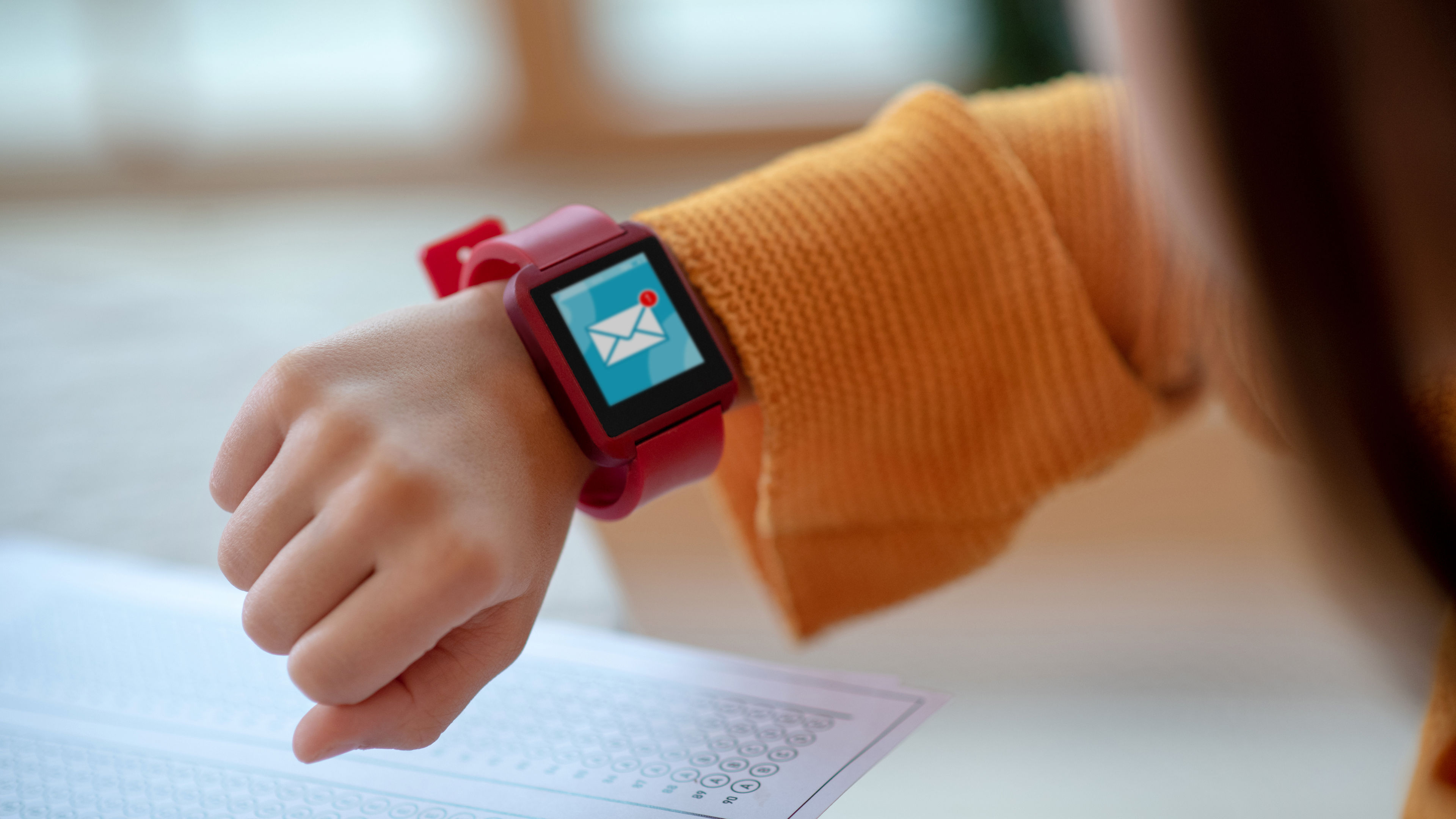 A close up of hands wearing a smartwatch, holding or adjusting the device.